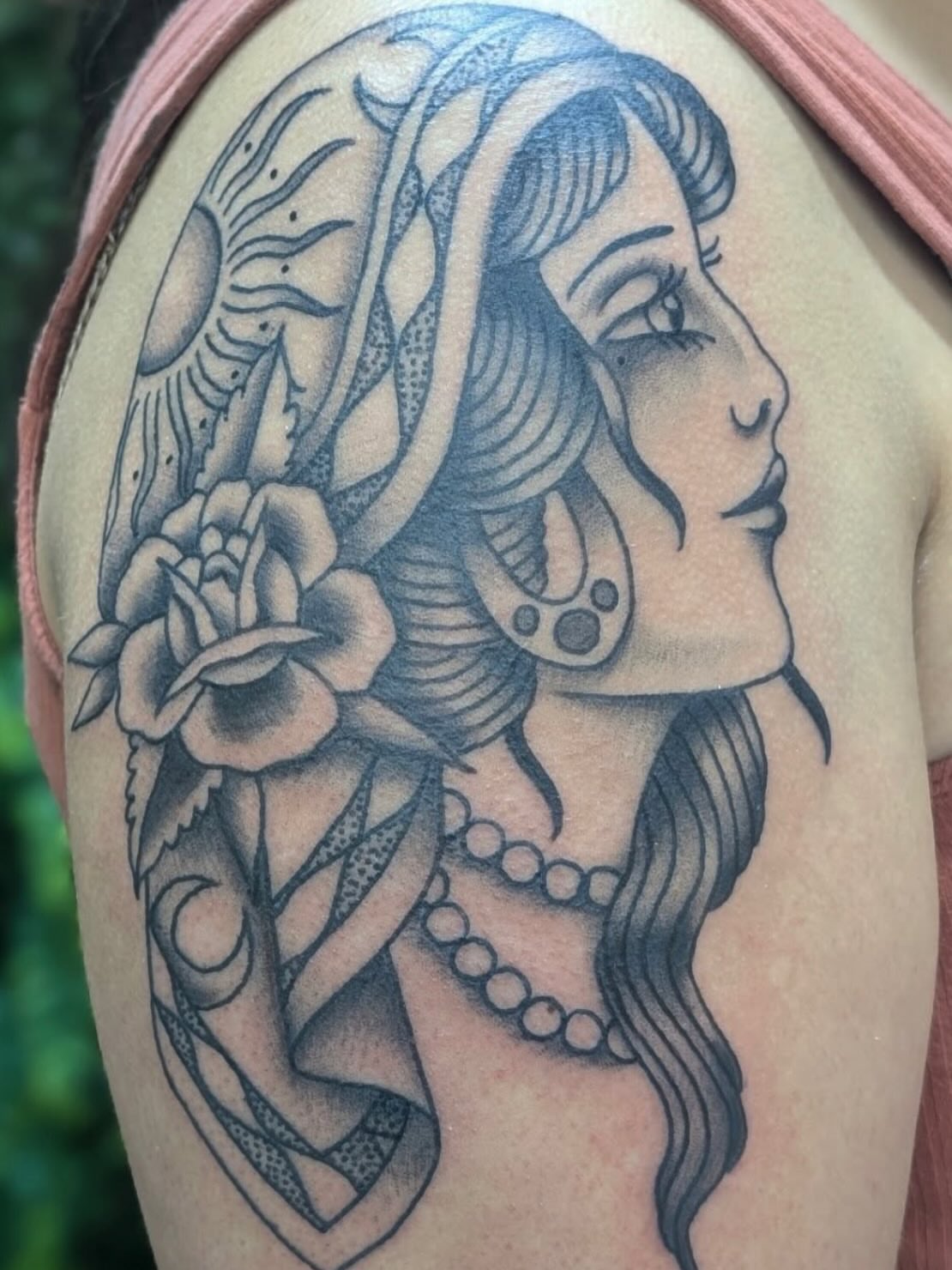 Woman with snake and flower American traditional tattoo on the shoulder by Alexandria Green