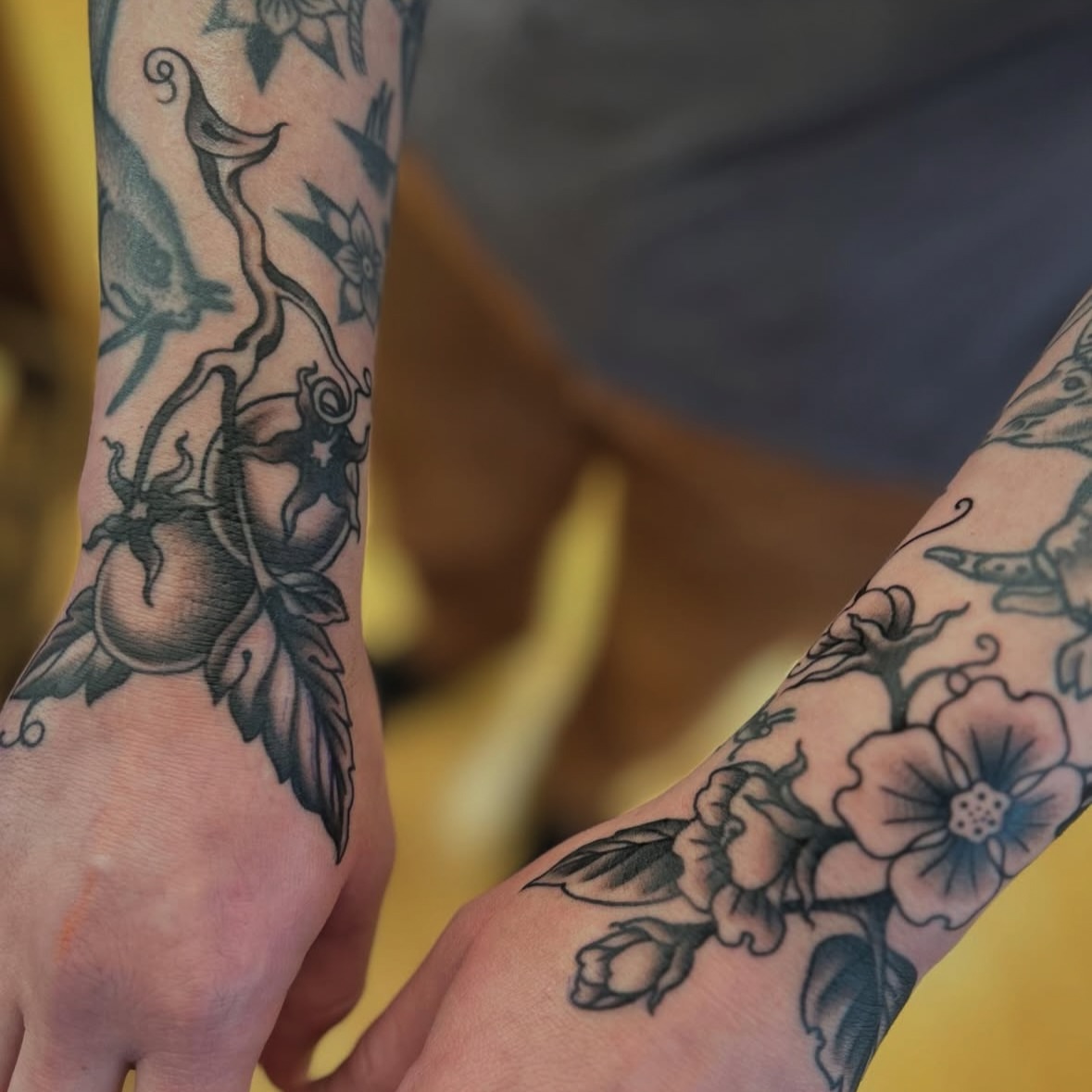 Peach and floral vine black and grey tattoo on the forearm by Matthew Crimson
