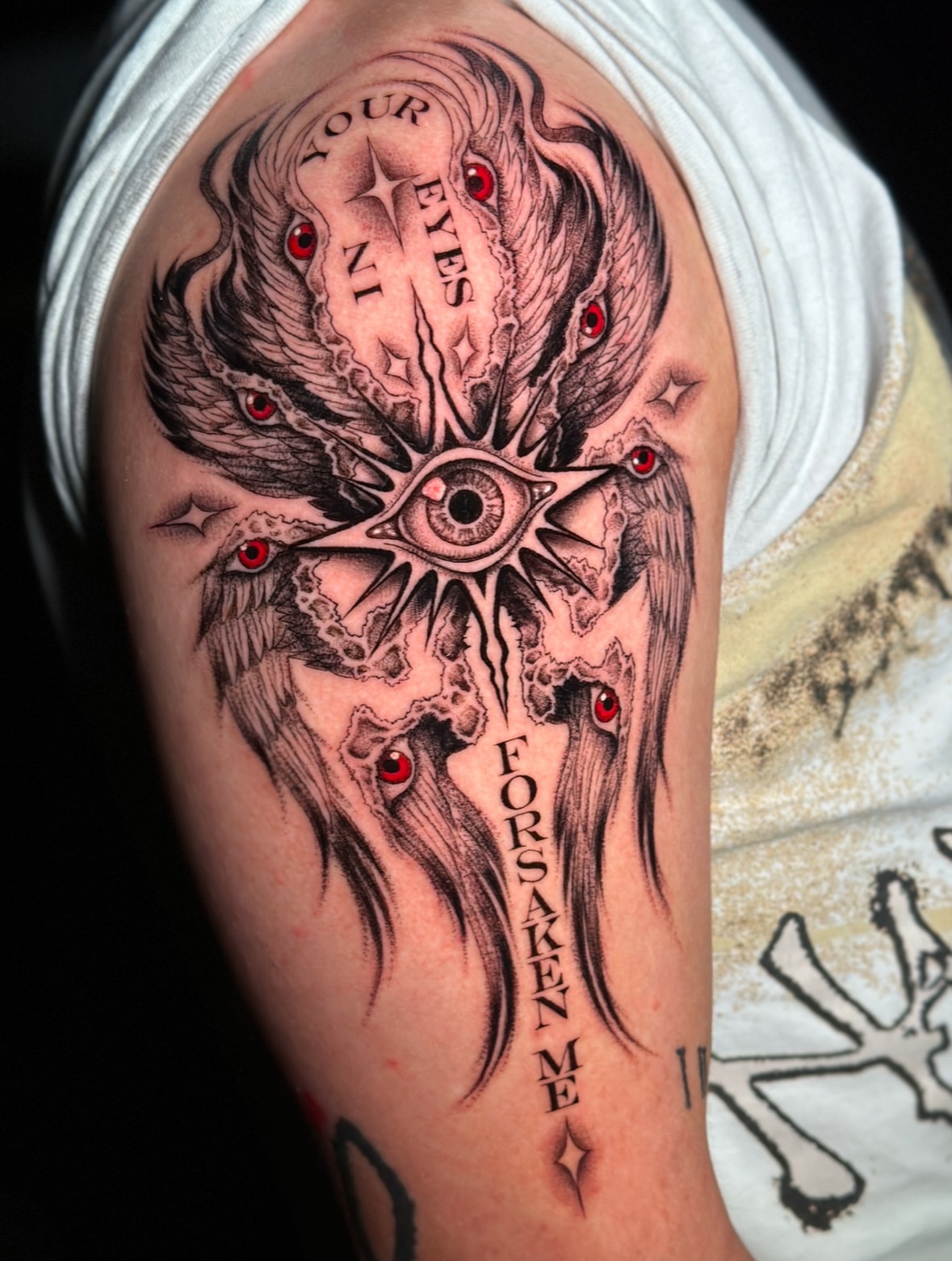 Eye and wings dark realism tattoo on the forearm by Fernanda Machado
