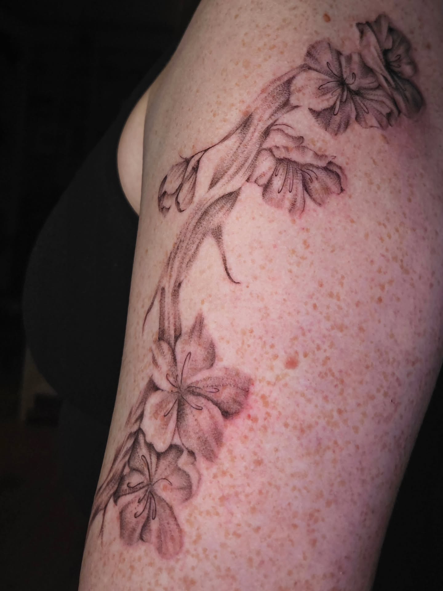 Flowers black and grey tattoo on the forearm by Courtlyn Bliss