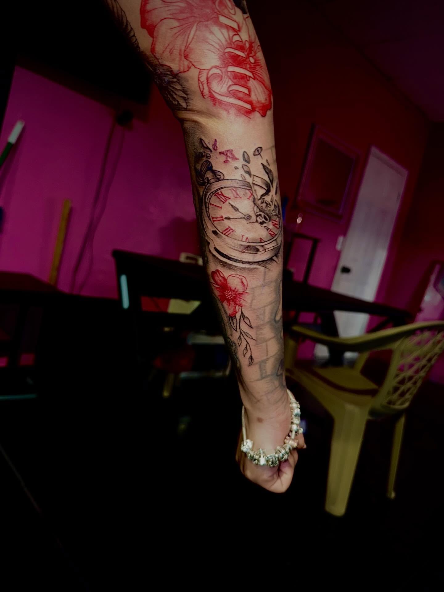 Clock and flowers American traditional tattoo on the forearm by Clifford Jordan