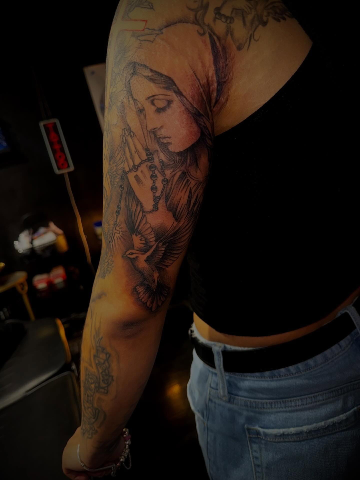 Praying woman realism tattoo on the forearm by Clifford Jordan