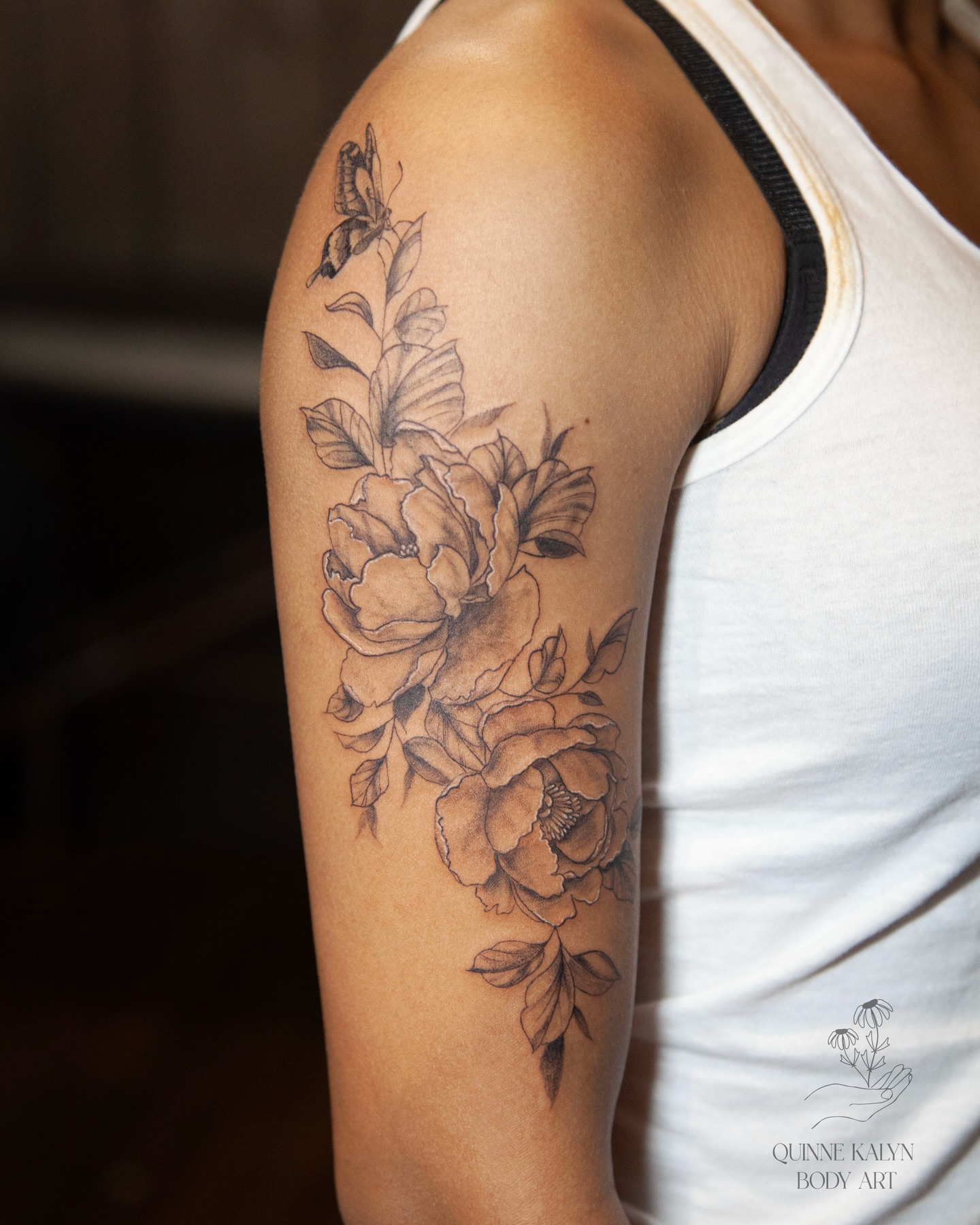 Peony flowers black and grey tattoo on the upper arm by Nashville Piercer & Tattoo Artist ✨ Quinne