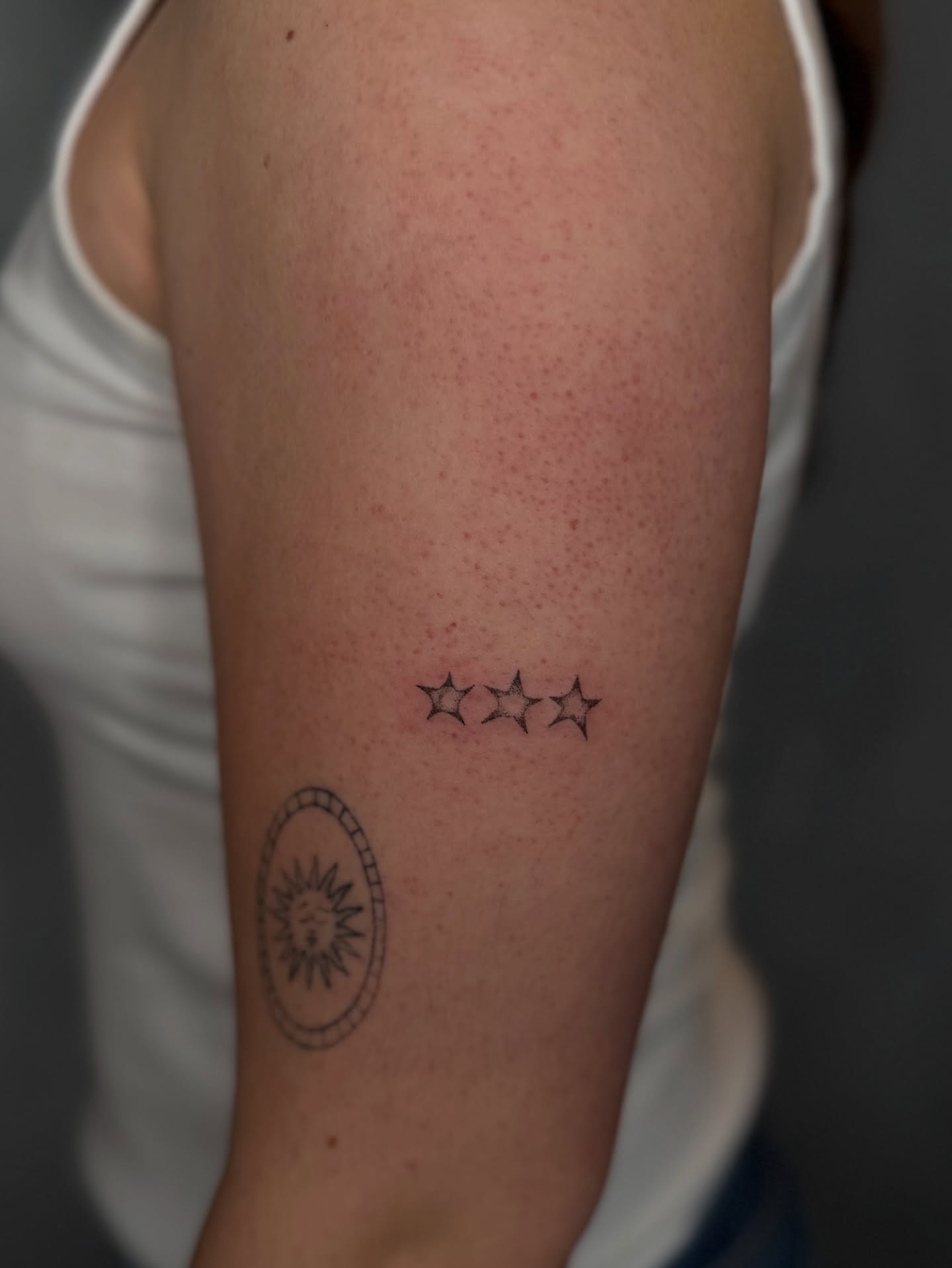 Stars fine line tattoo on the forearm by Fineline Tattoos DFW