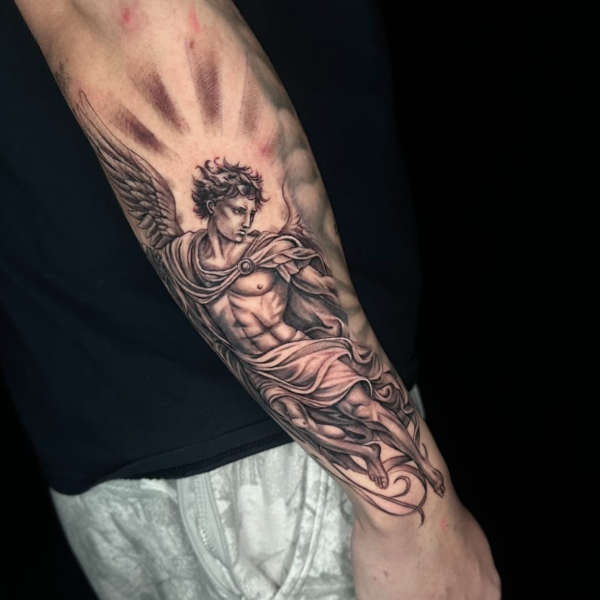 Angelic figure realism tattoo on the forearm by Angela Azure
