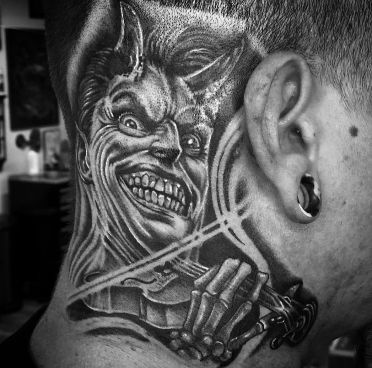 Demon face dotwork tattoo on the neck by Big Steve Lewis