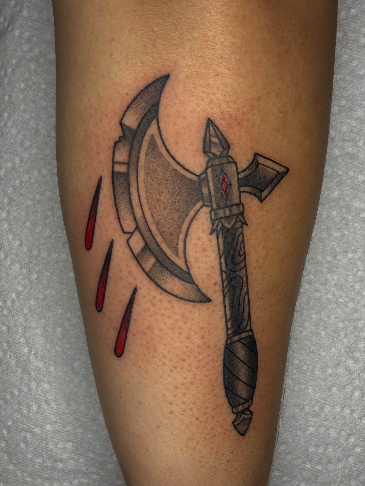Ax and blood black and grey tattoo on the forearm by Lance 🦈