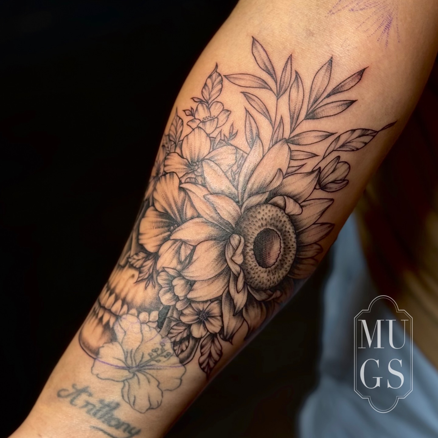 Floral bouquet realism tattoo on the forearm by Emily Andreozzi