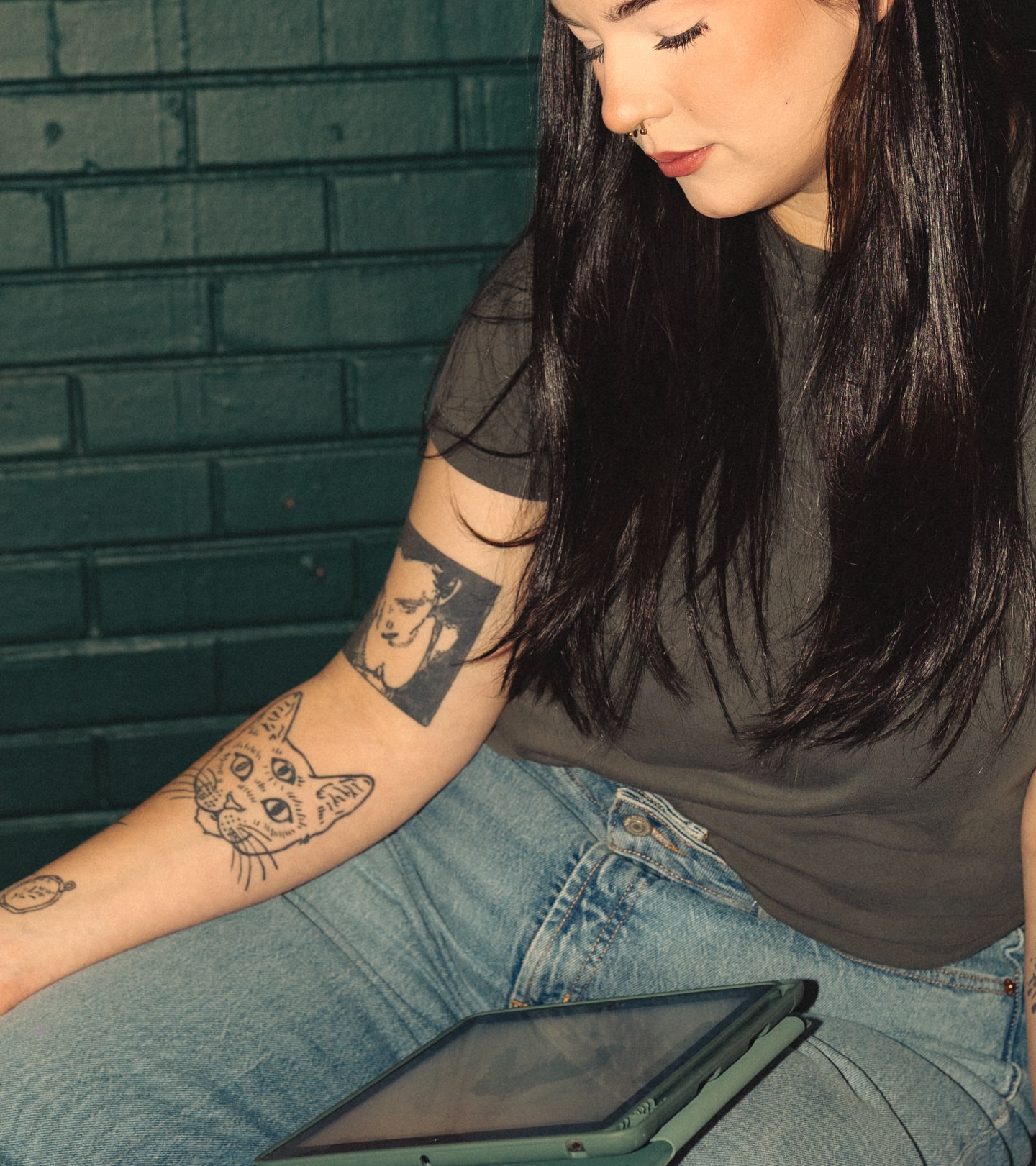 Cat black and grey tattoo on the forearm by Lexi