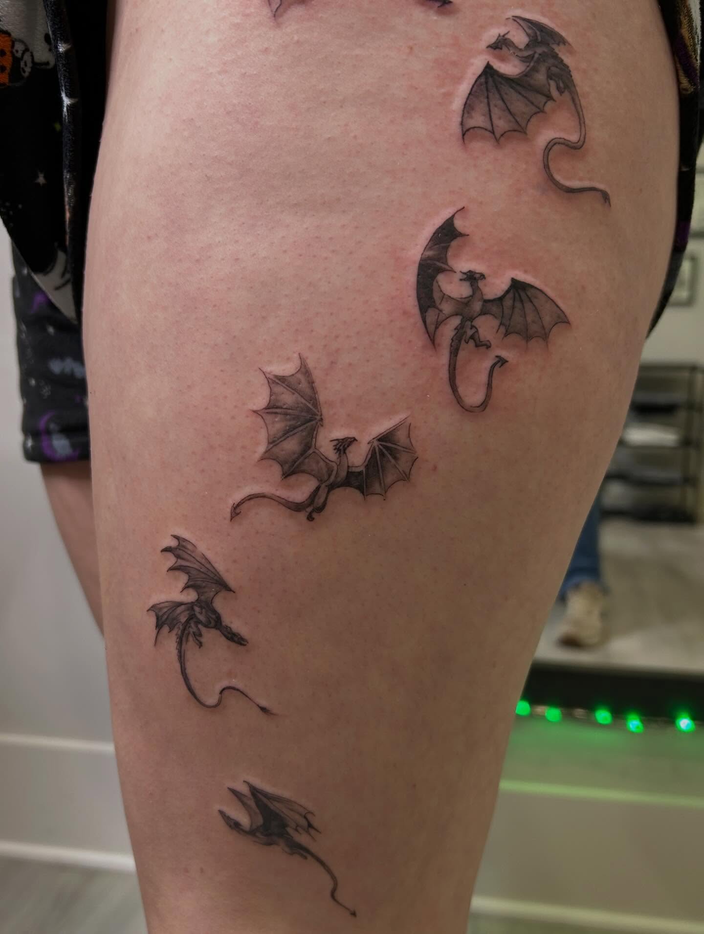 Dragons black and grey tattoo on the thigh by Jbtattoo Artistry