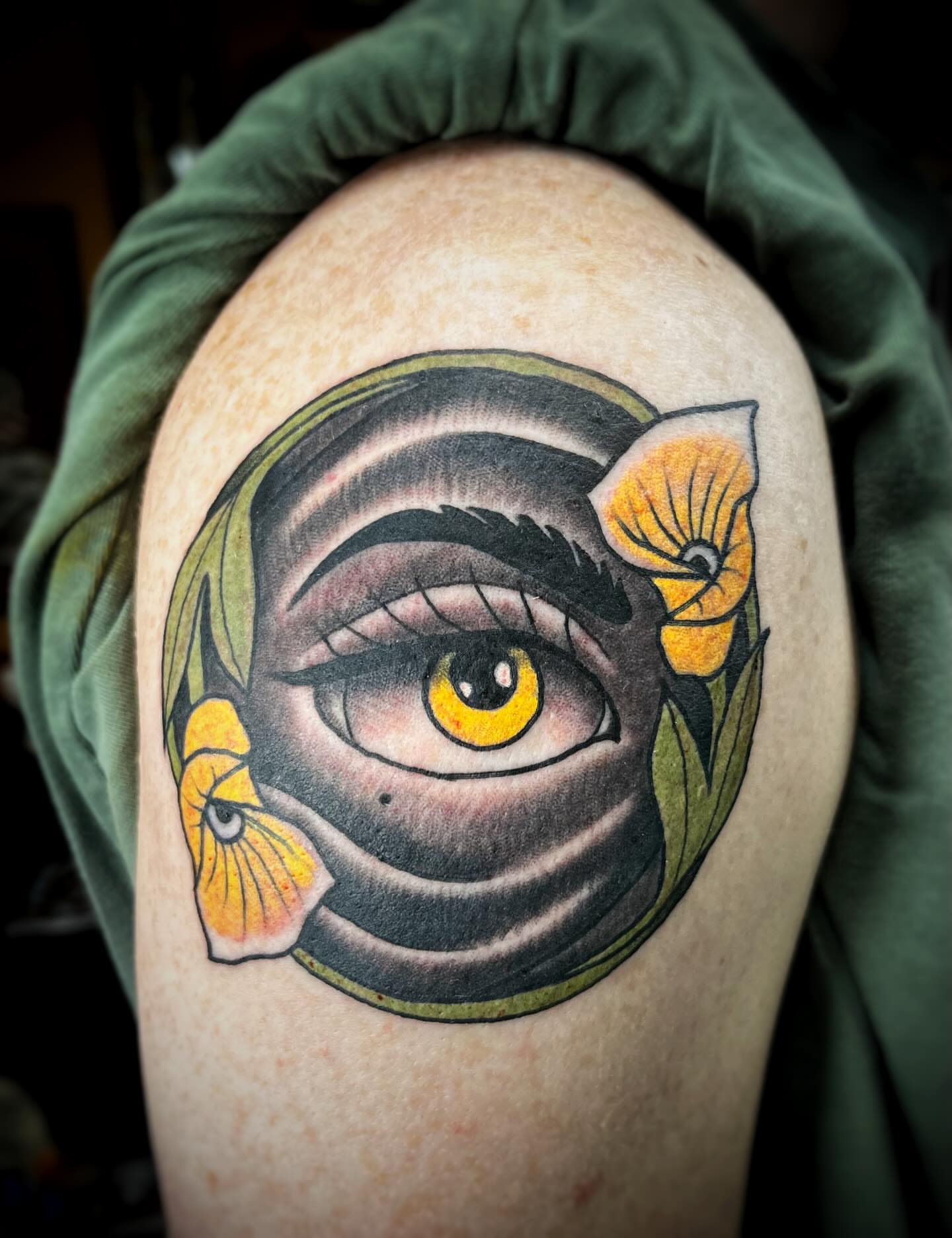 Eye with flowers American traditional tattoo on the shoulder by Gilbert Gonzalez
