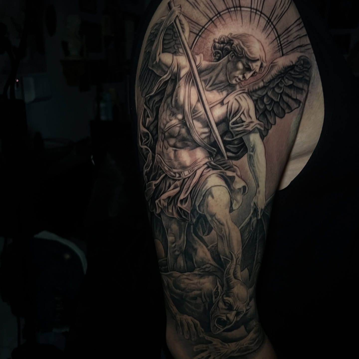 Angel slaying demon realism tattoo on the forearm by Flames, Cerritos, California