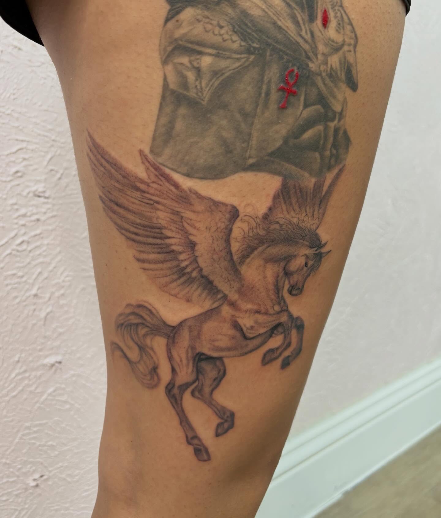 Pegasus black and grey tattoo on the thigh by Jackie π€