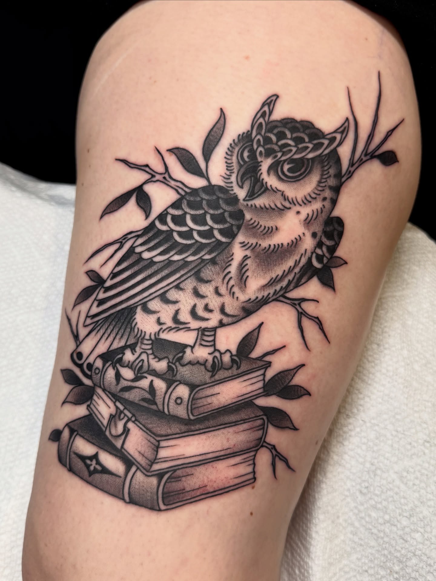 Owl and books black and grey tattoo on the thigh by Christopher  Cousins, Nashville, Tennessee