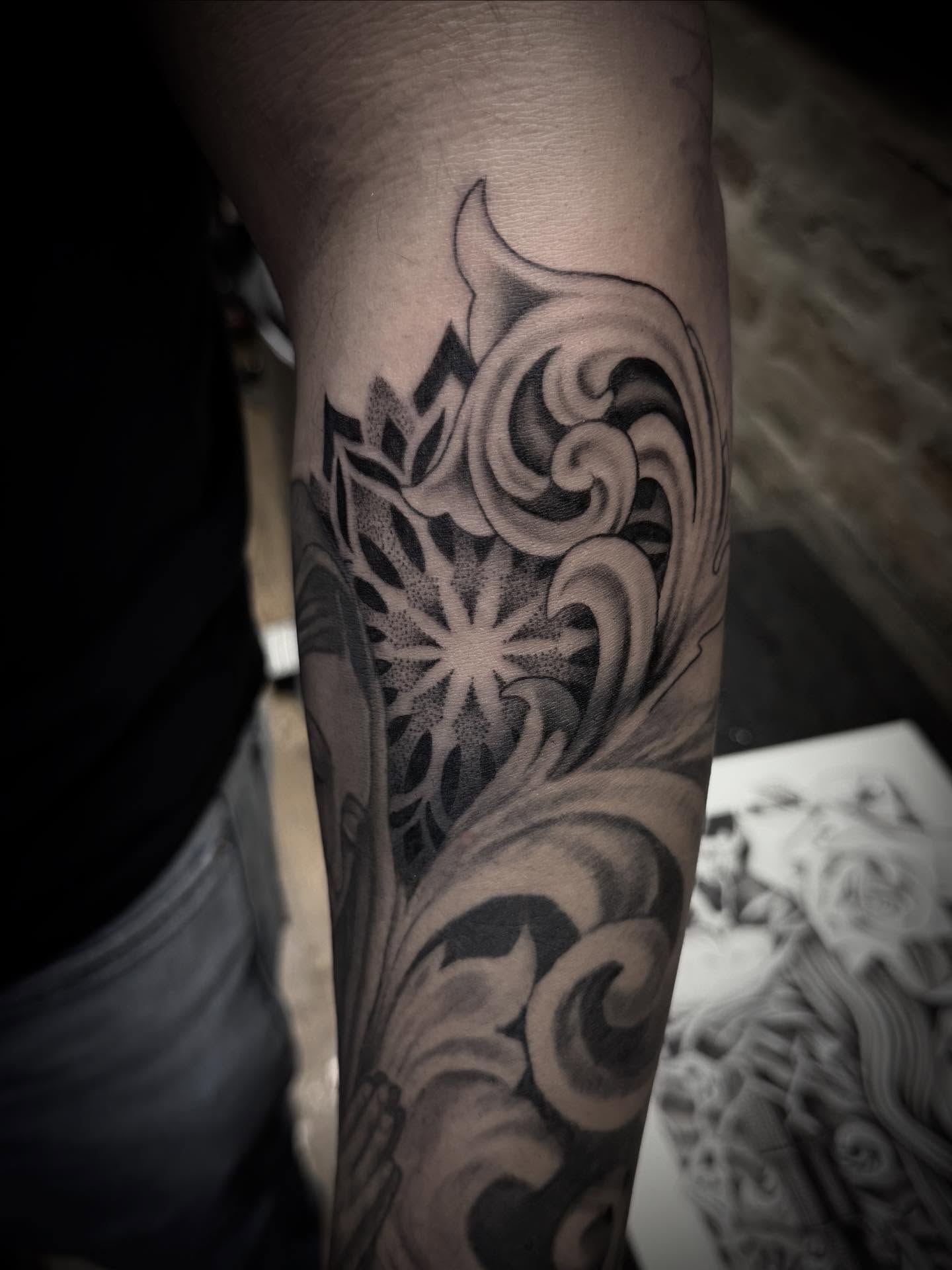 Wave and sunburst dotwork tattoo on the forearm by Jameson William Cowan