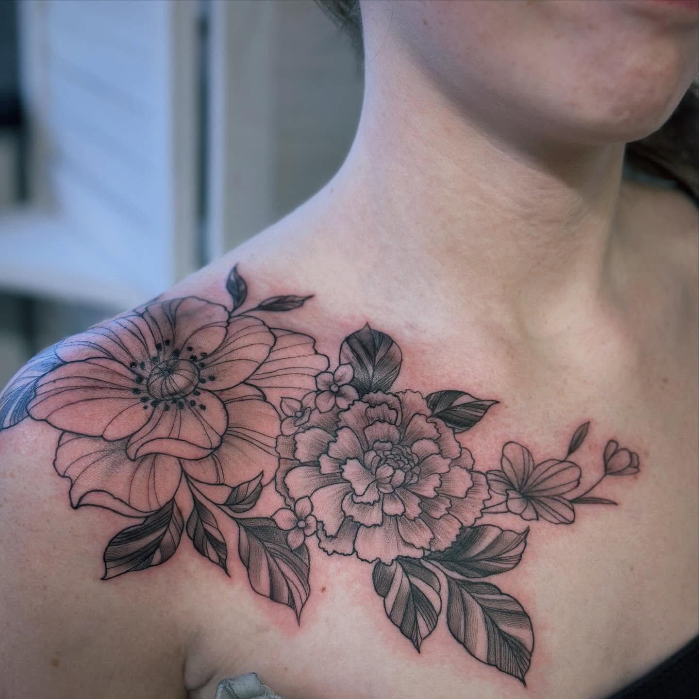 Floral bouquet black and grey tattoo on the shoulder by Teddi Bird