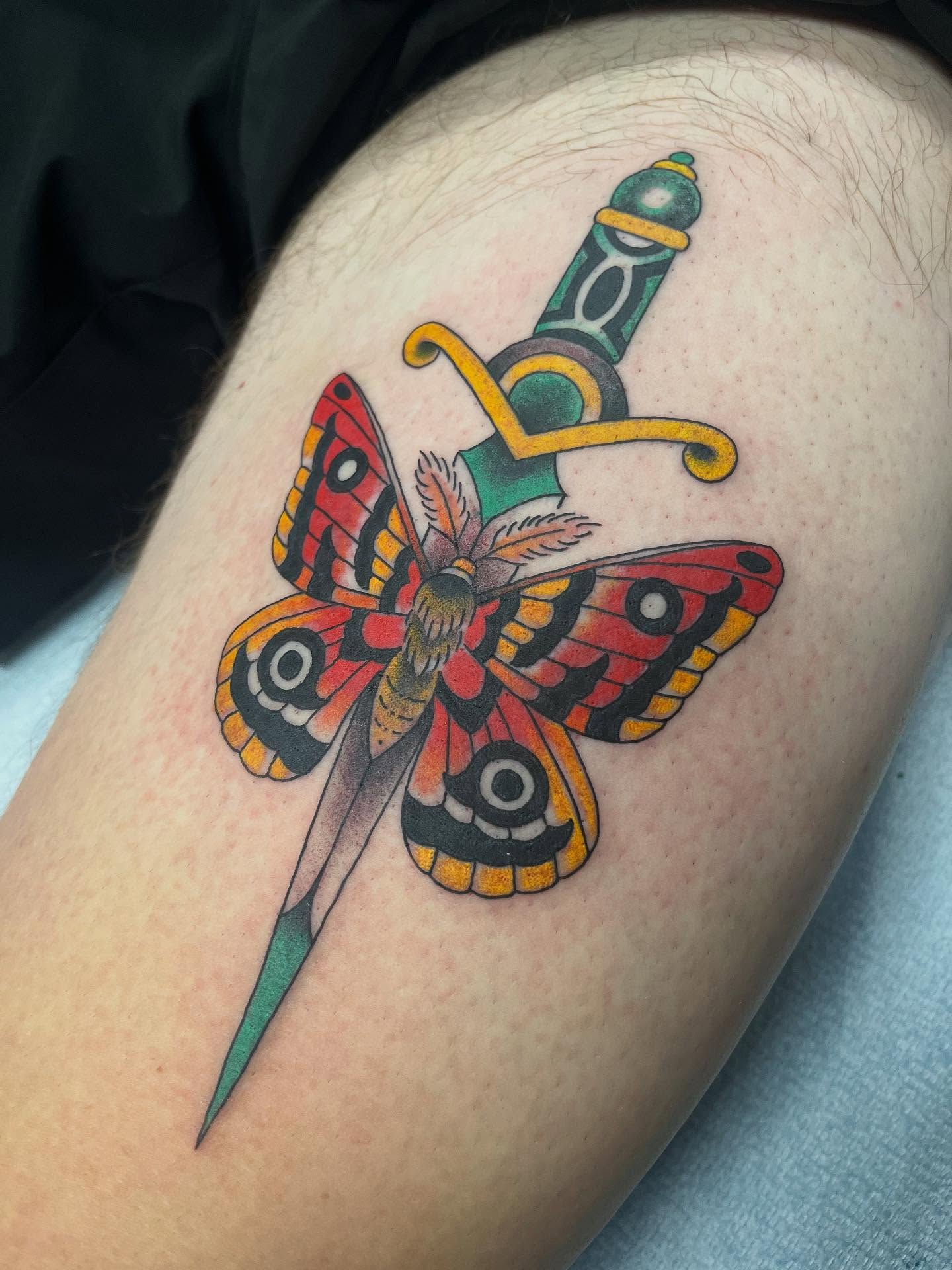 Butterfly and dagger American traditional tattoo on the thigh by Brian Mcfadden
