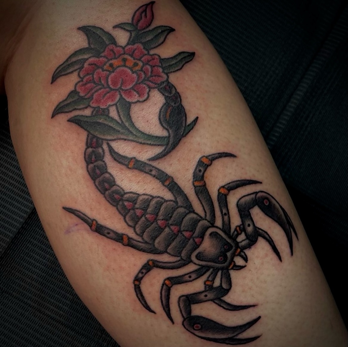Scorpion and flower American traditional tattoo on the thigh by Kat McCoy Guidera, Nashville, Tennessee
