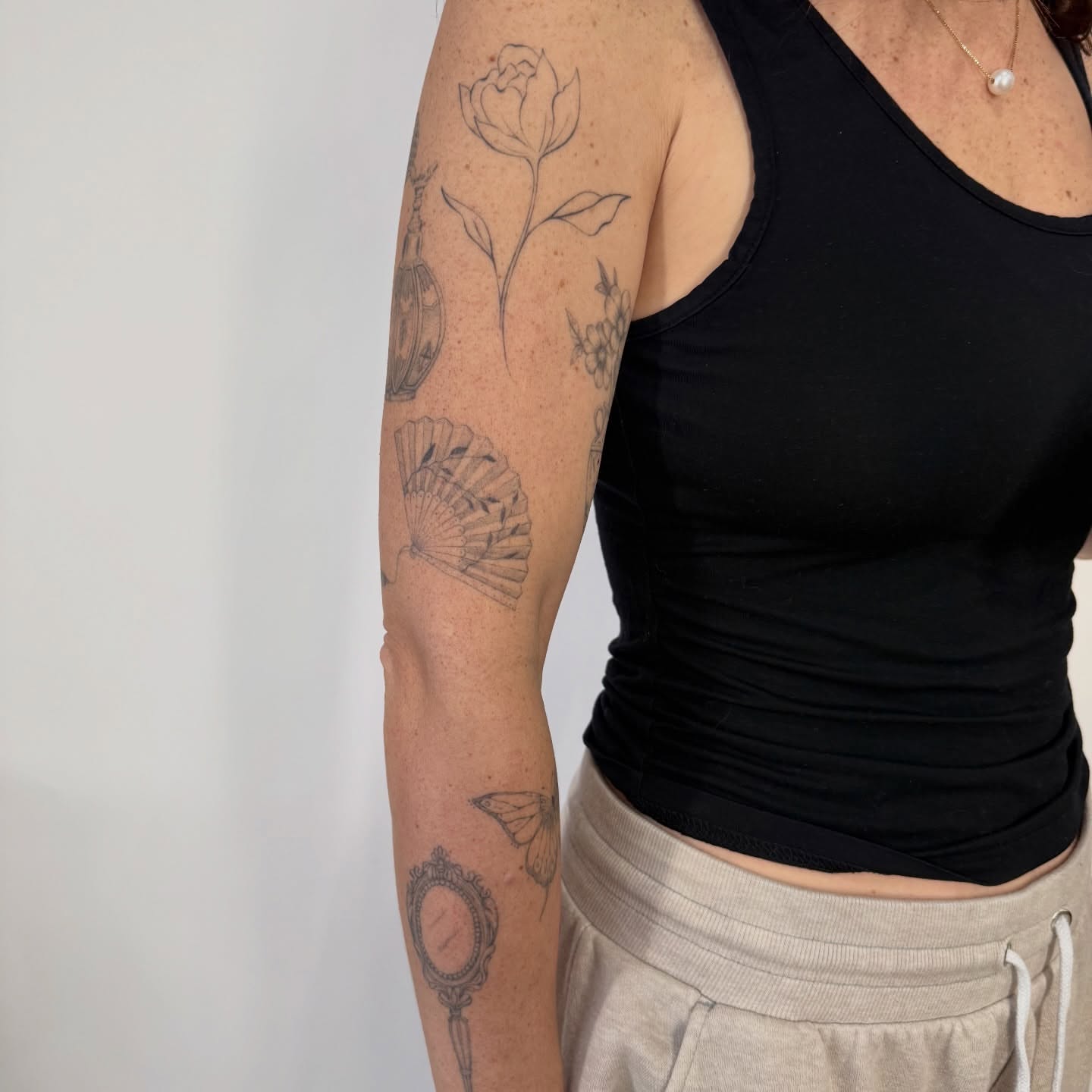 Floral arrangement black and grey tattoo on the forearm by bre