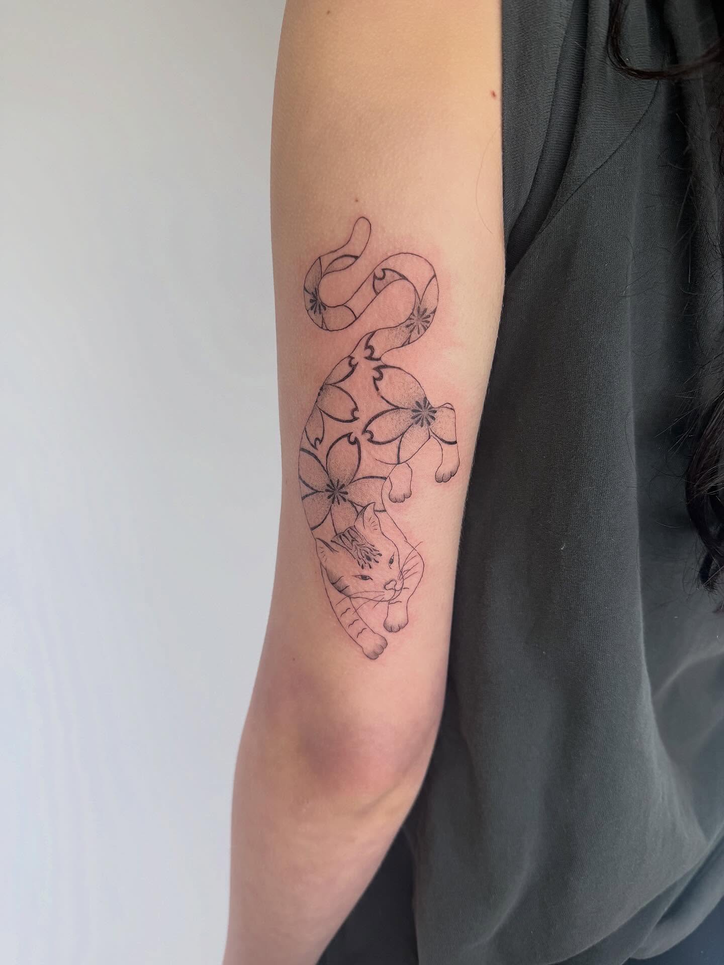 Cat and floral pattern black and grey tattoo on the forearm by Leah Ramos