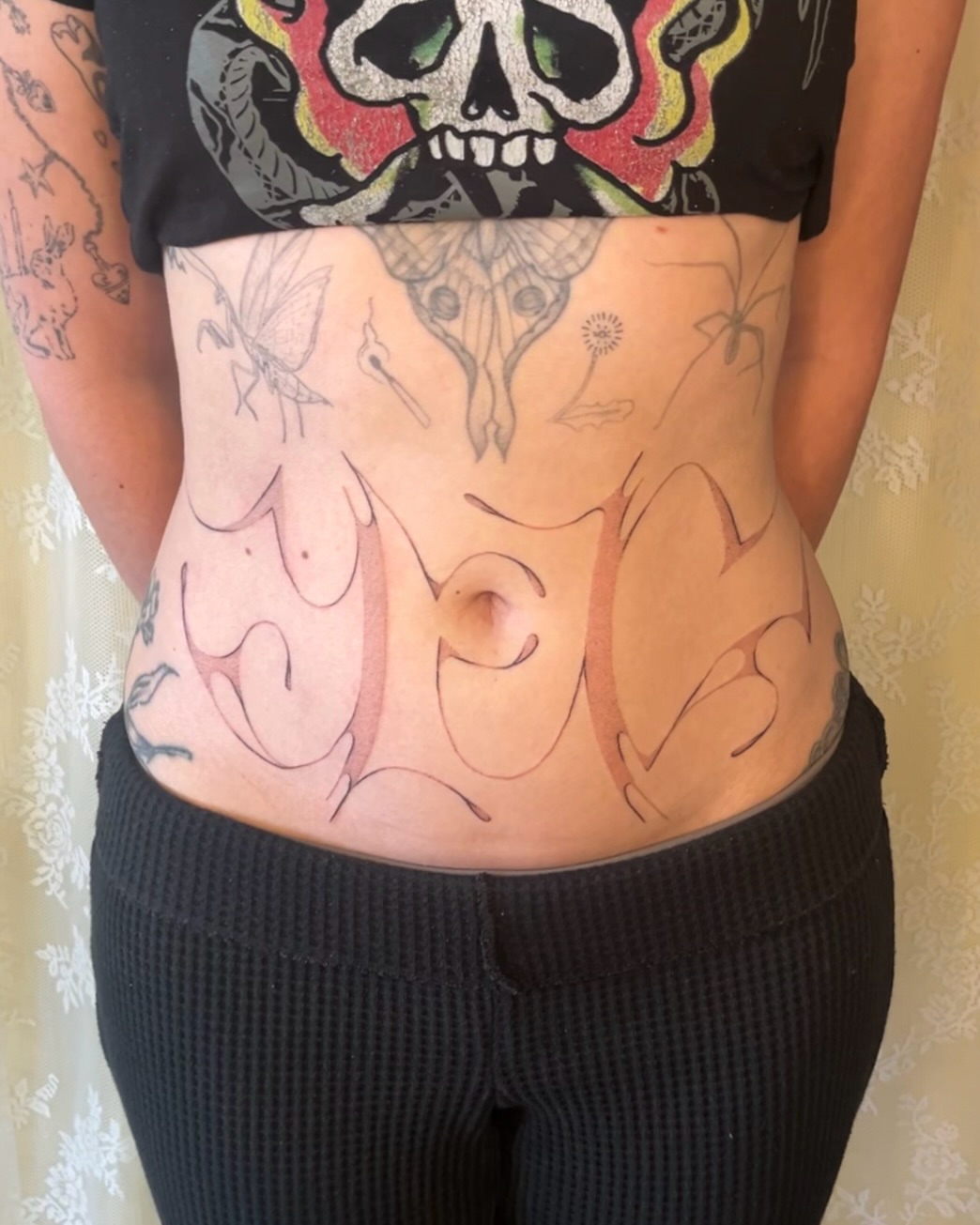 Skull and flame American traditional tattoo on the torso by mia