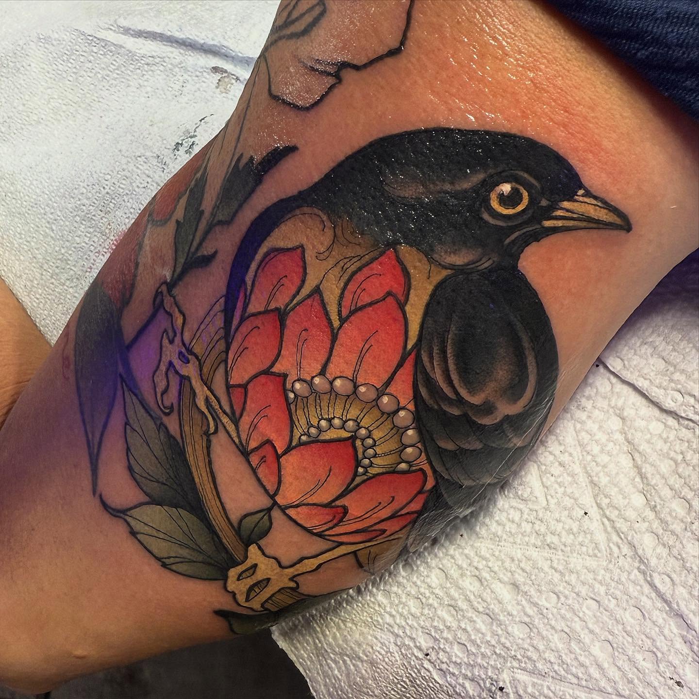 Bird and flower realism tattoo on the forearm by Jason Lawyer
