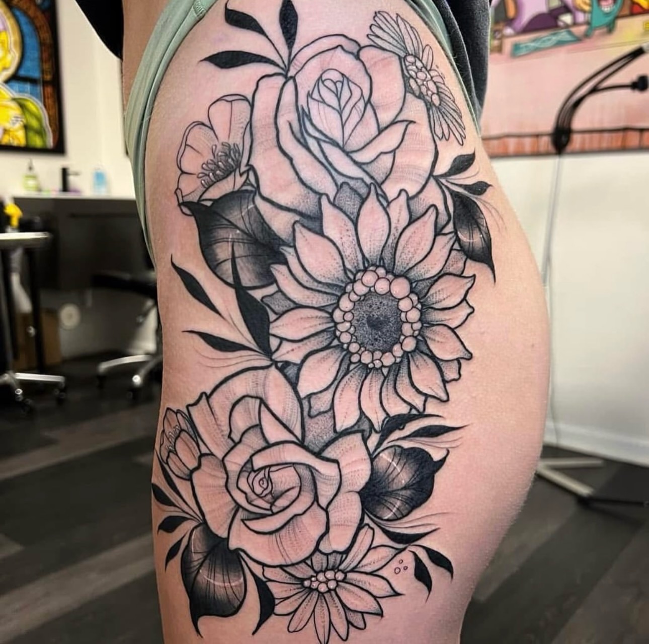Floral bouquet black and grey tattoo on the thigh by Caitlyn