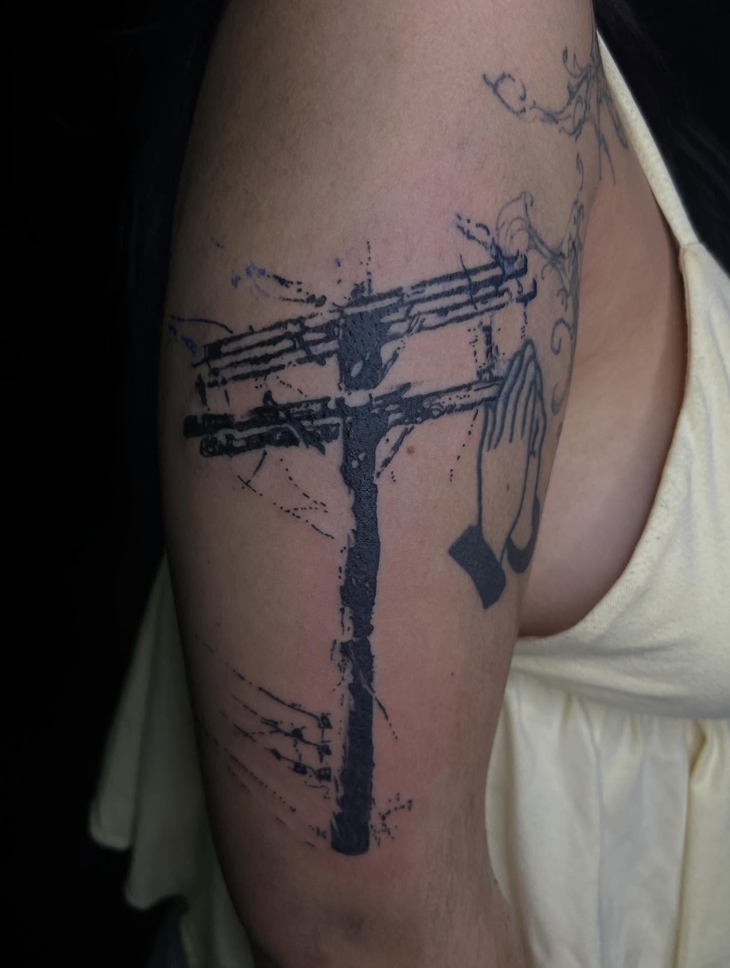 Cross with hands black and grey tattoo on the thigh by @halfwit__