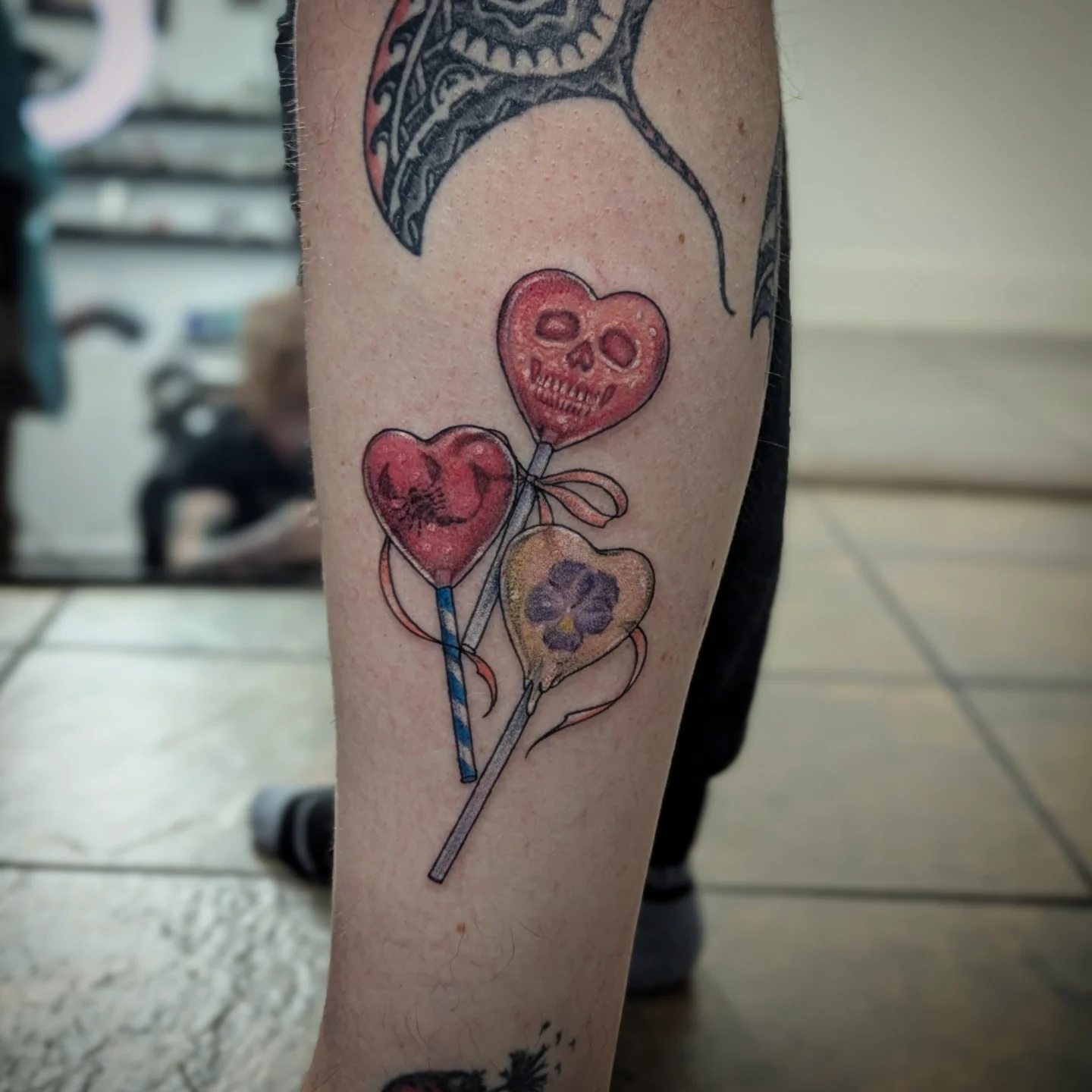 Heart-shaped lollipops dotwork tattoo on the forearm by Lorelei