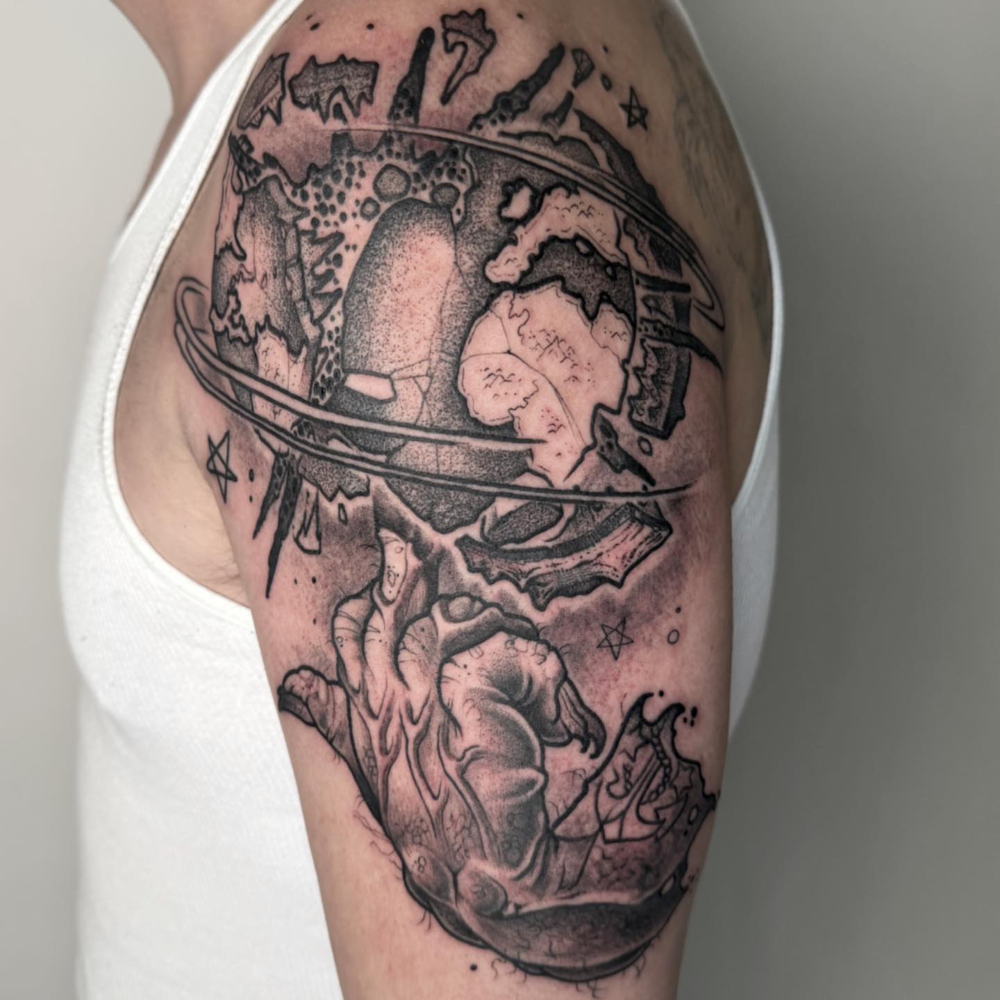 Global map dotwork tattoo on the shoulder by Tattoos by Aeron Herald Maurbjorn, Sioux