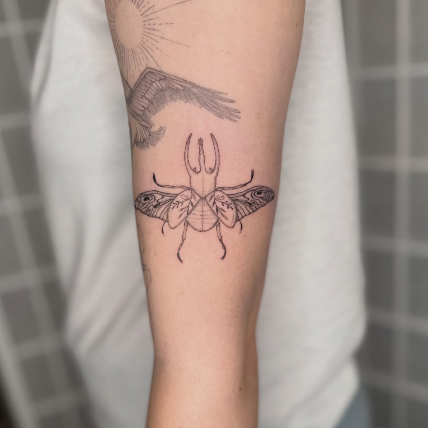 Moth geometric tattoo on the forearm by Dama