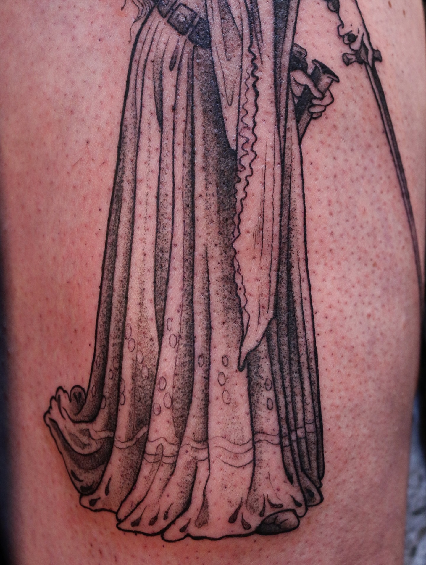 Robe and staff black and grey tattoo on the leg by Summer Balcom M.
