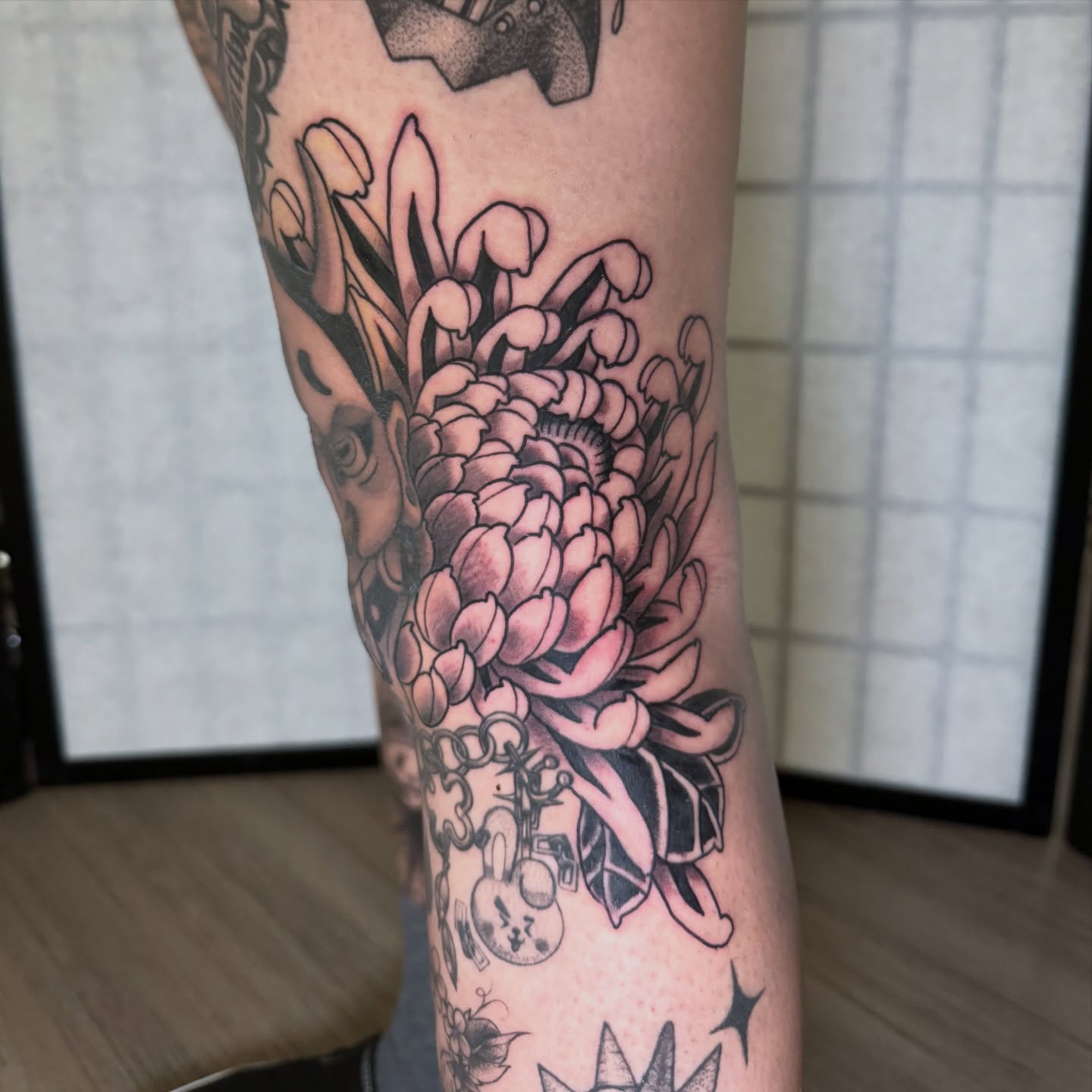 Chrysanthemum black and grey tattoo on the forearm by Dylan