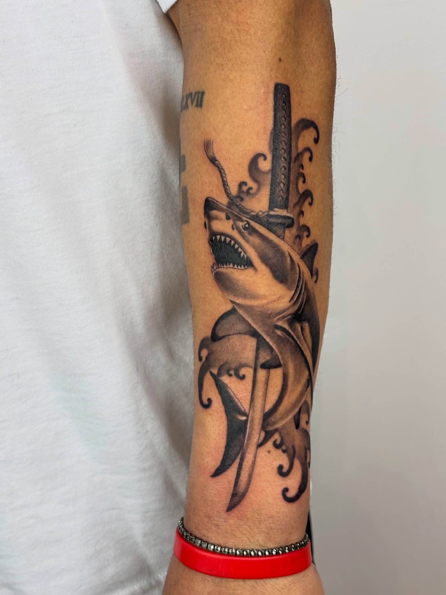 Shark with katana realism tattoo on the forearm by Dani