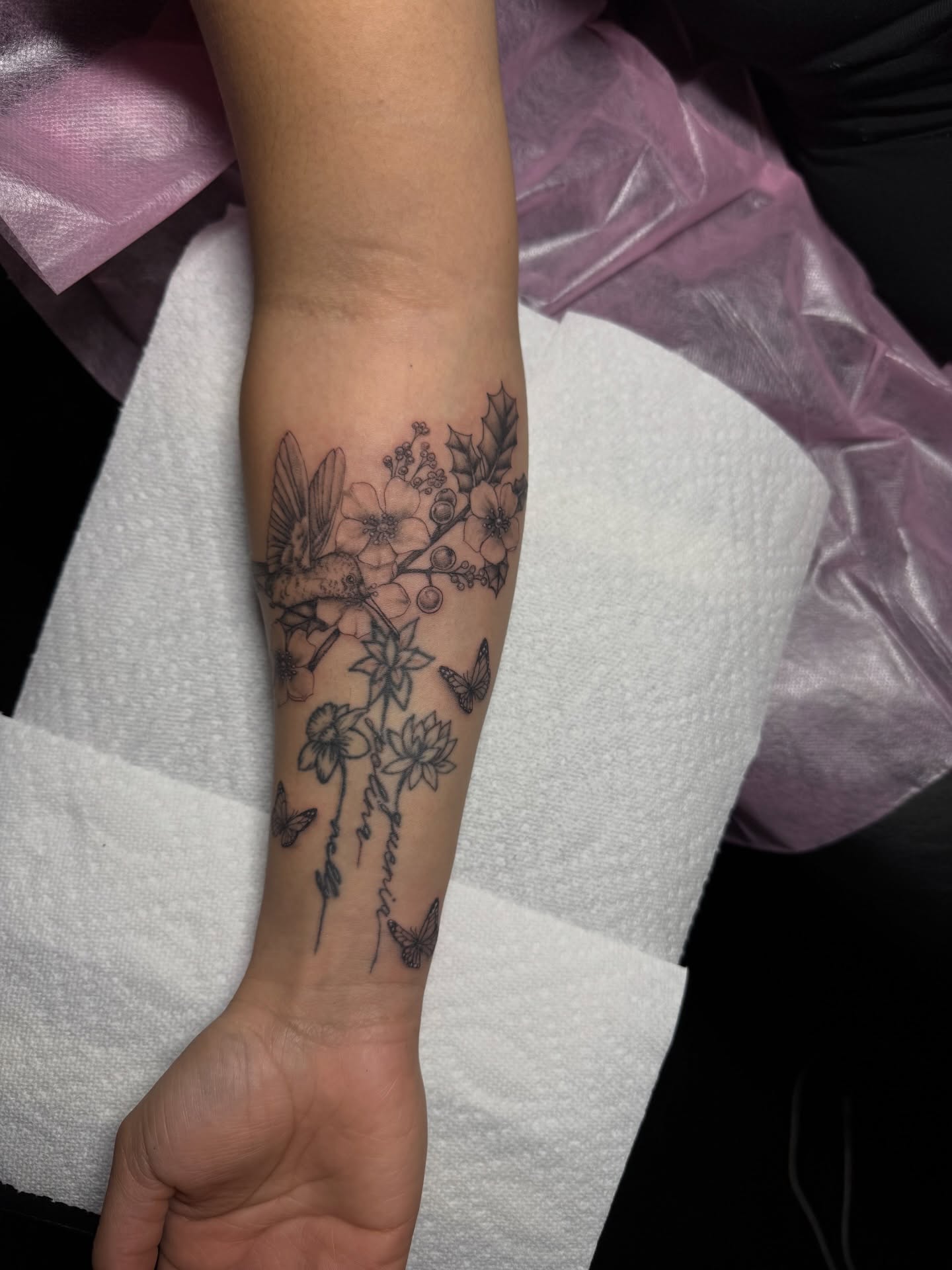 Flower branch with butterflies black and grey tattoo on the forearm by Nathalie Briseno