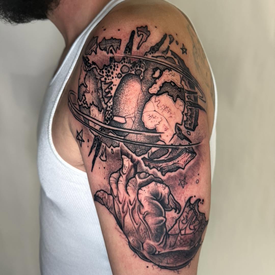 Astronaut globe dotwork tattoo on the shoulder by Tattoos by Aeron Herald Maurbjorn, Sioux