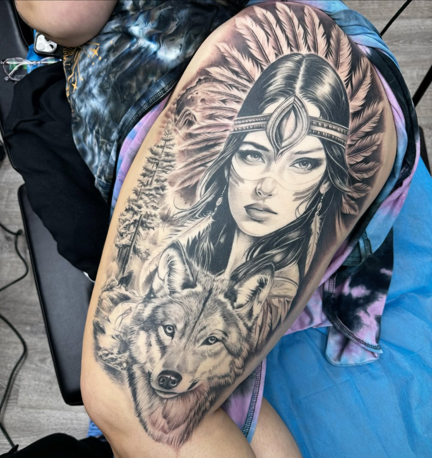 Woman with wolf realism tattoo on the forearm by Mike Hudson