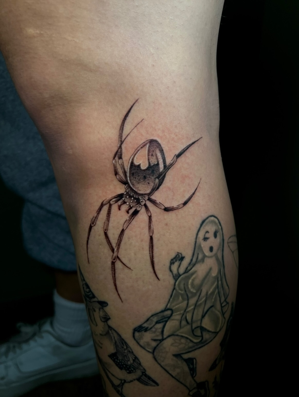 Spider and ghost realism tattoo on the thigh by Jacob Sass