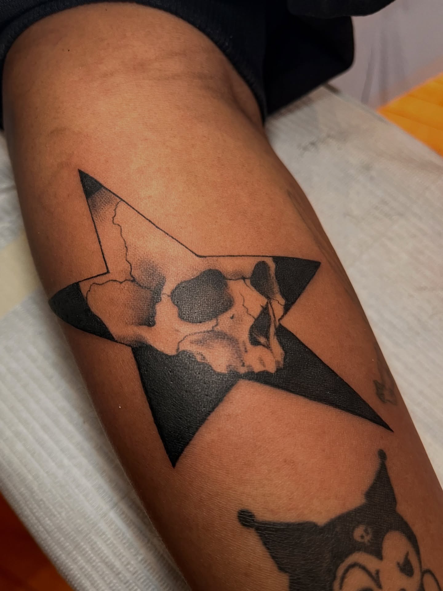 Skull within star dotwork tattoo on the forearm by Zoe Phan, Richmond, Virginia
