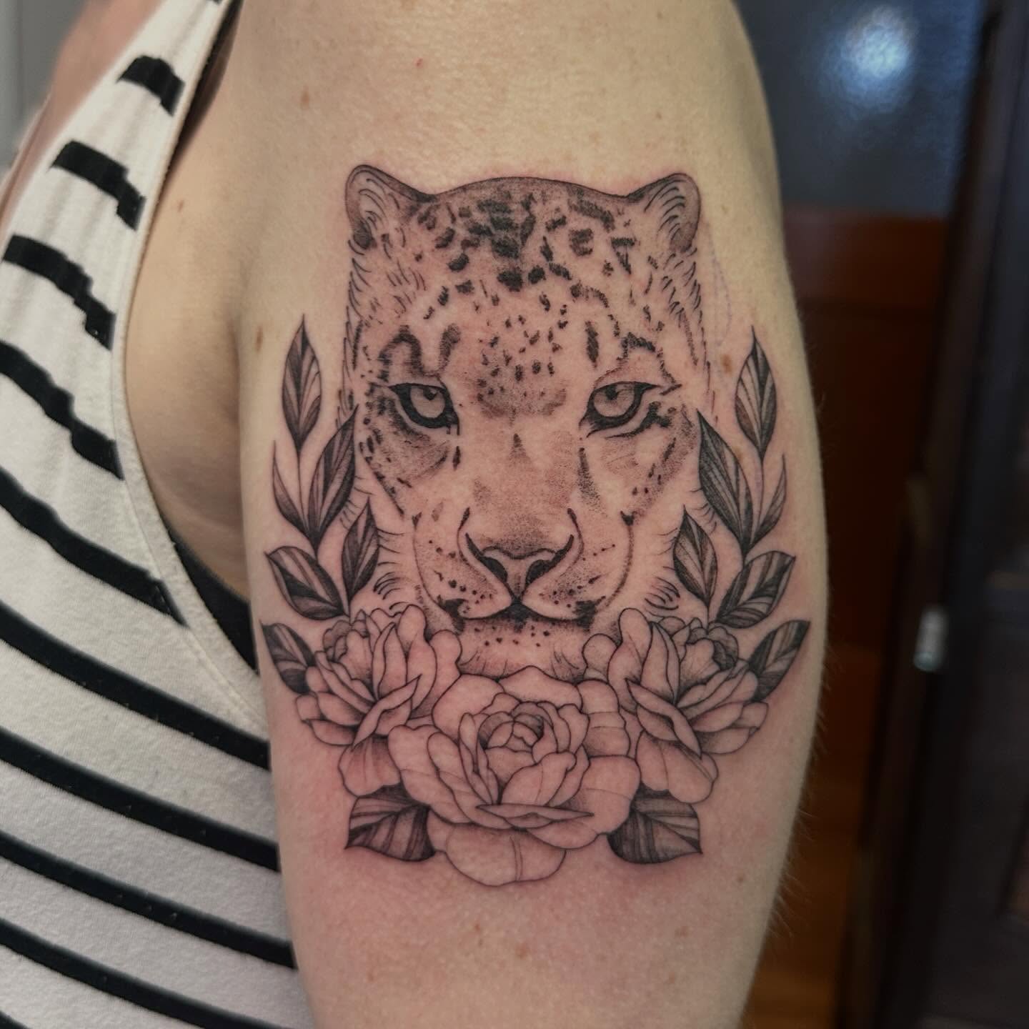 Snow leopard and roses realism tattoo on the forearm by Raul Najera Tattoo, Plano, Texas