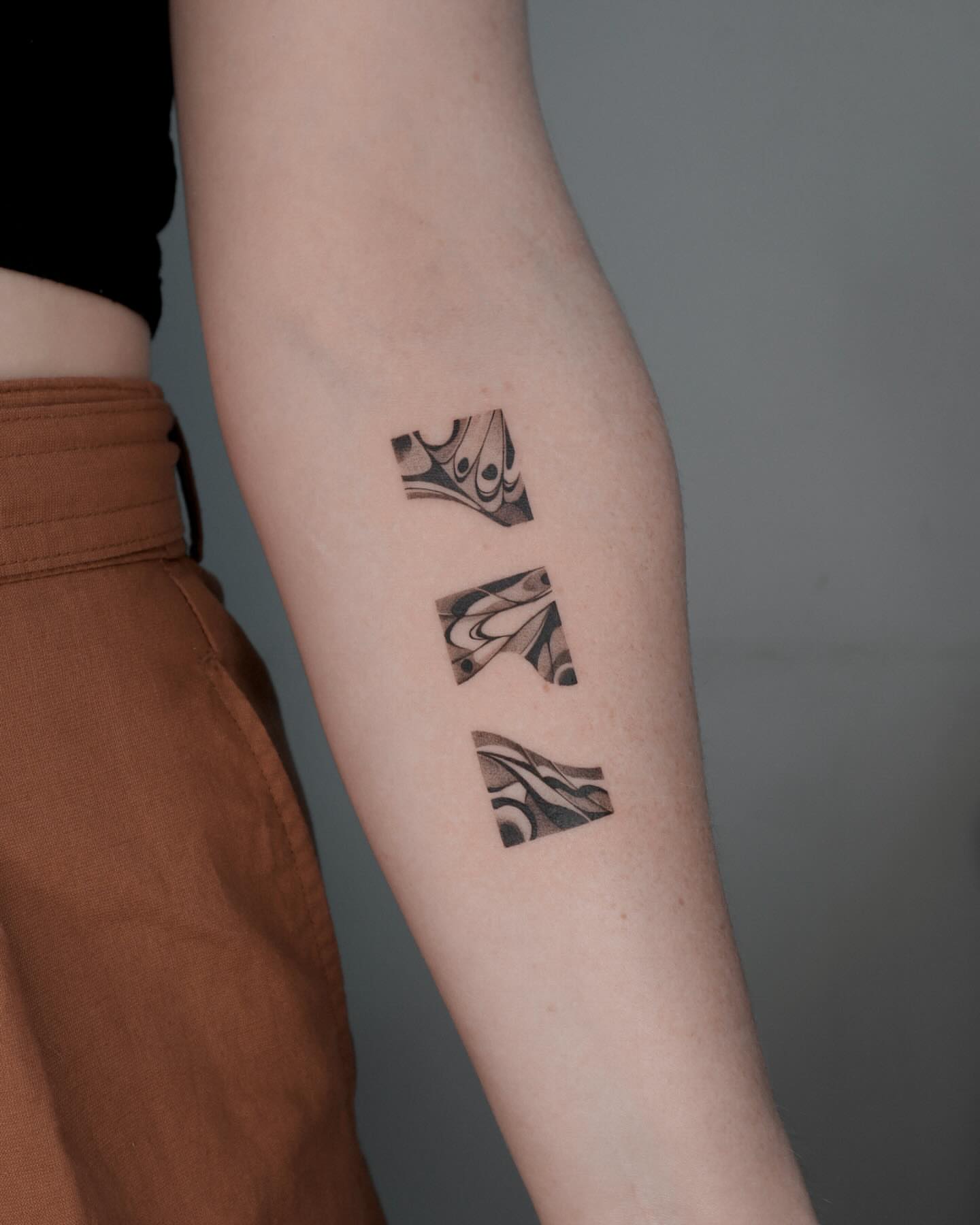 Abstract pattern black and grey tattoo on the forearm by River, New York, New York