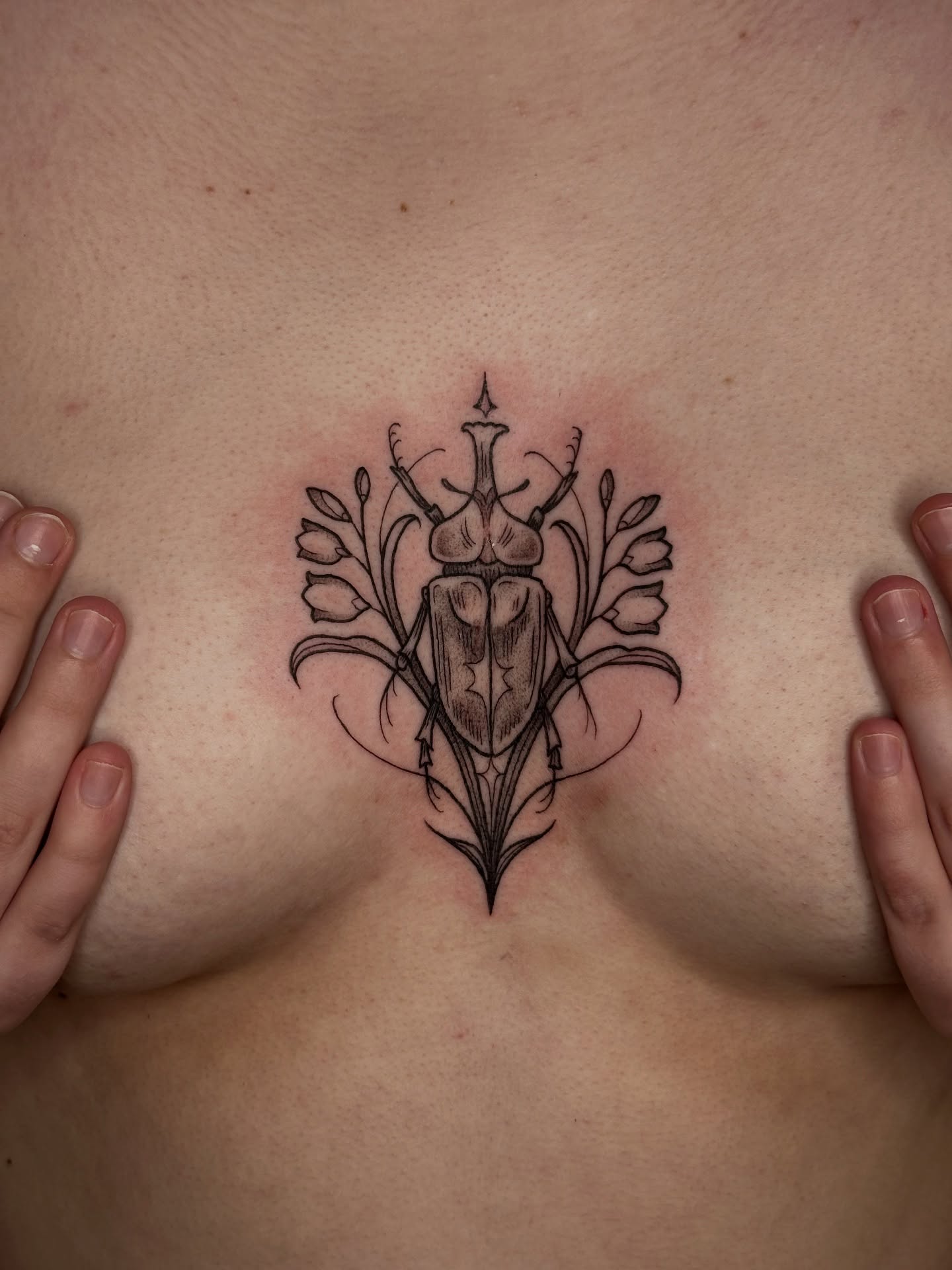 Scarab beetle black and grey tattoo on the chest by Summer Shield