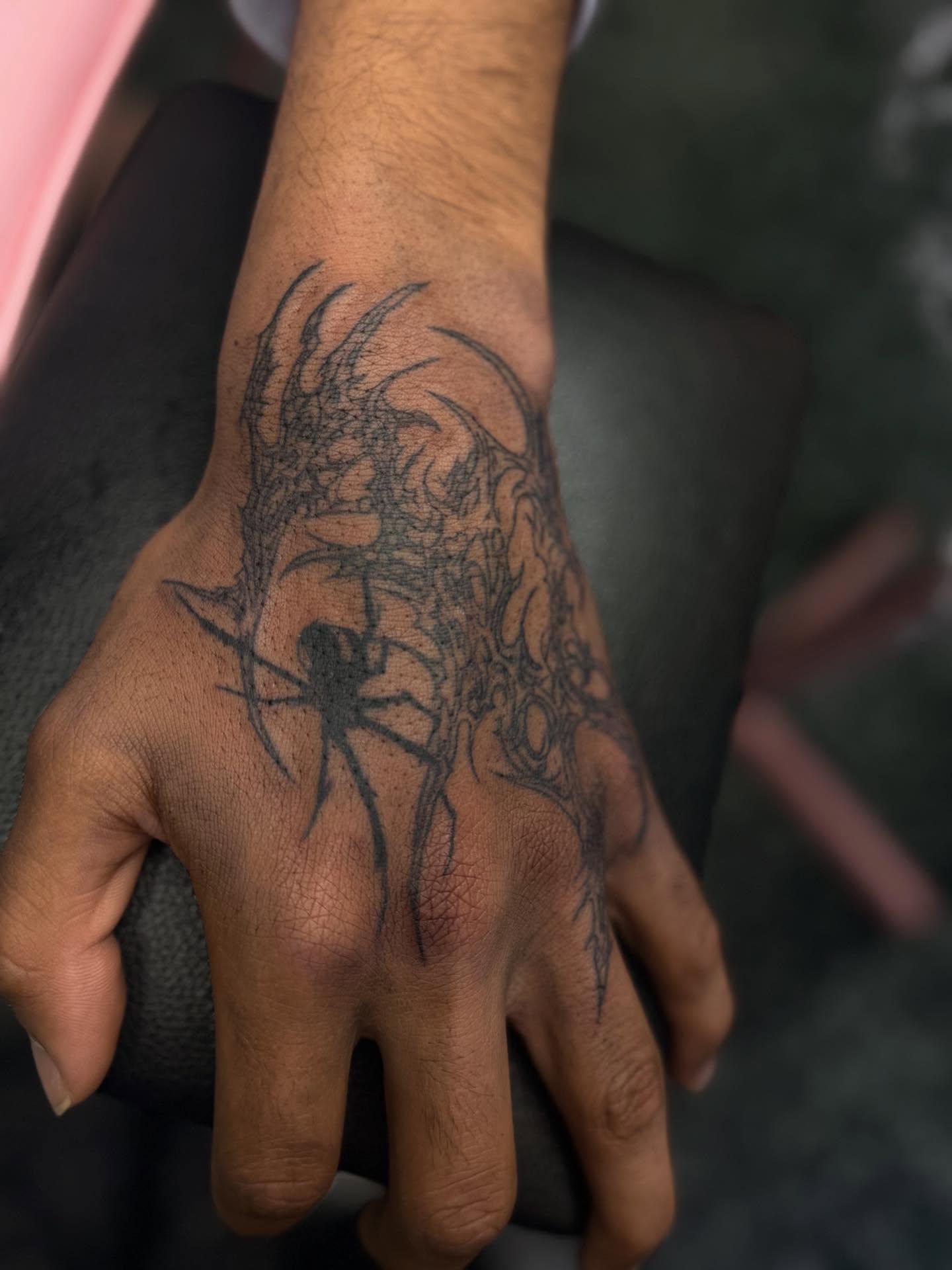 Dragon black and grey tattoo on the hand by Tattoos by Santos