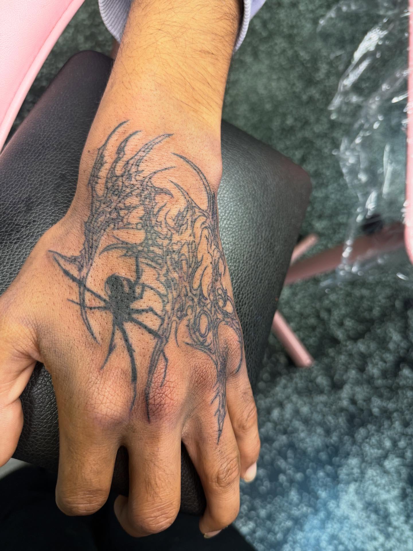 Spider black and grey tattoo on the hand by Tattoos by Santos