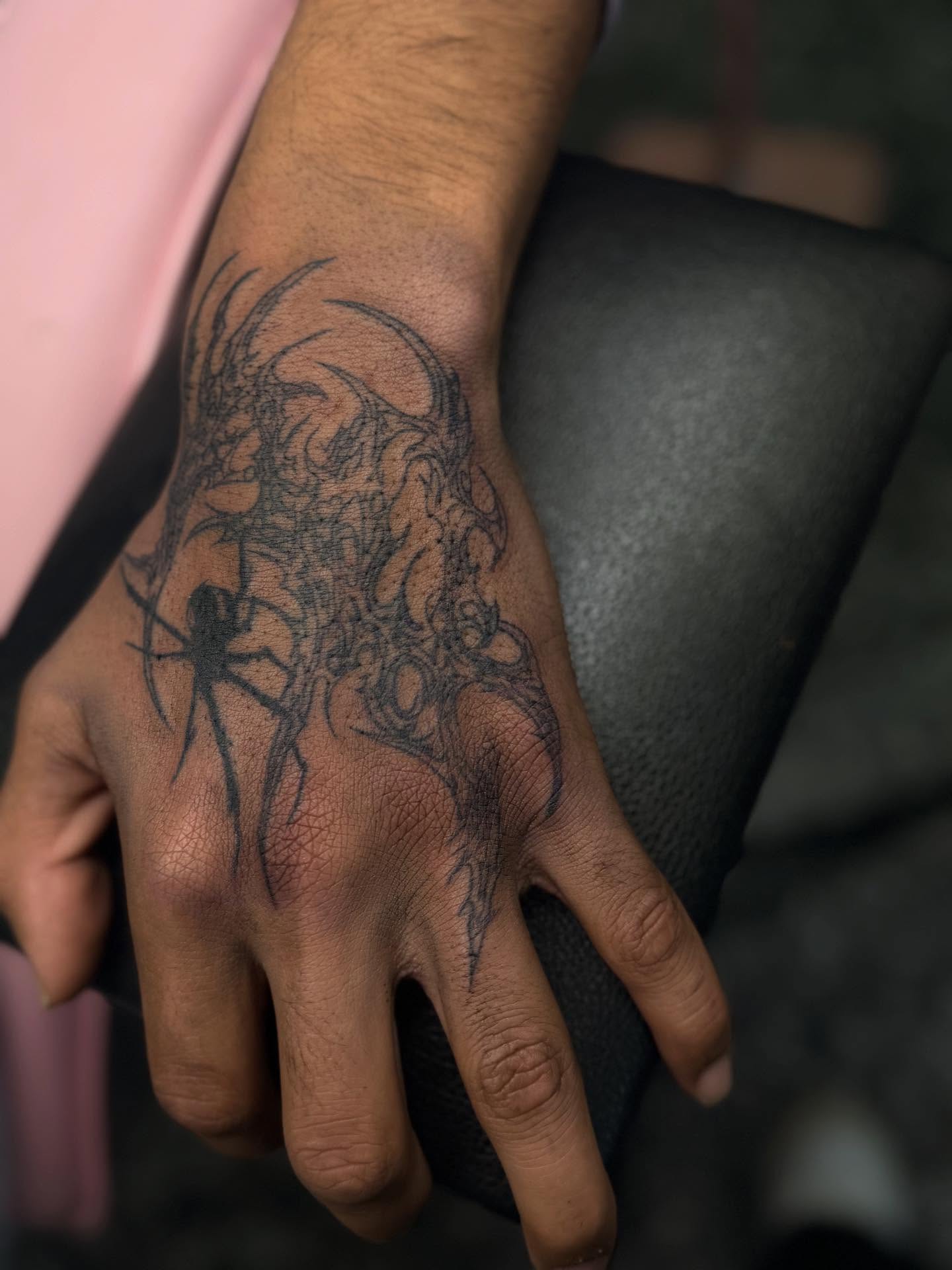 Spider and skull black and grey tattoo on the hand by Tattoos by Santos