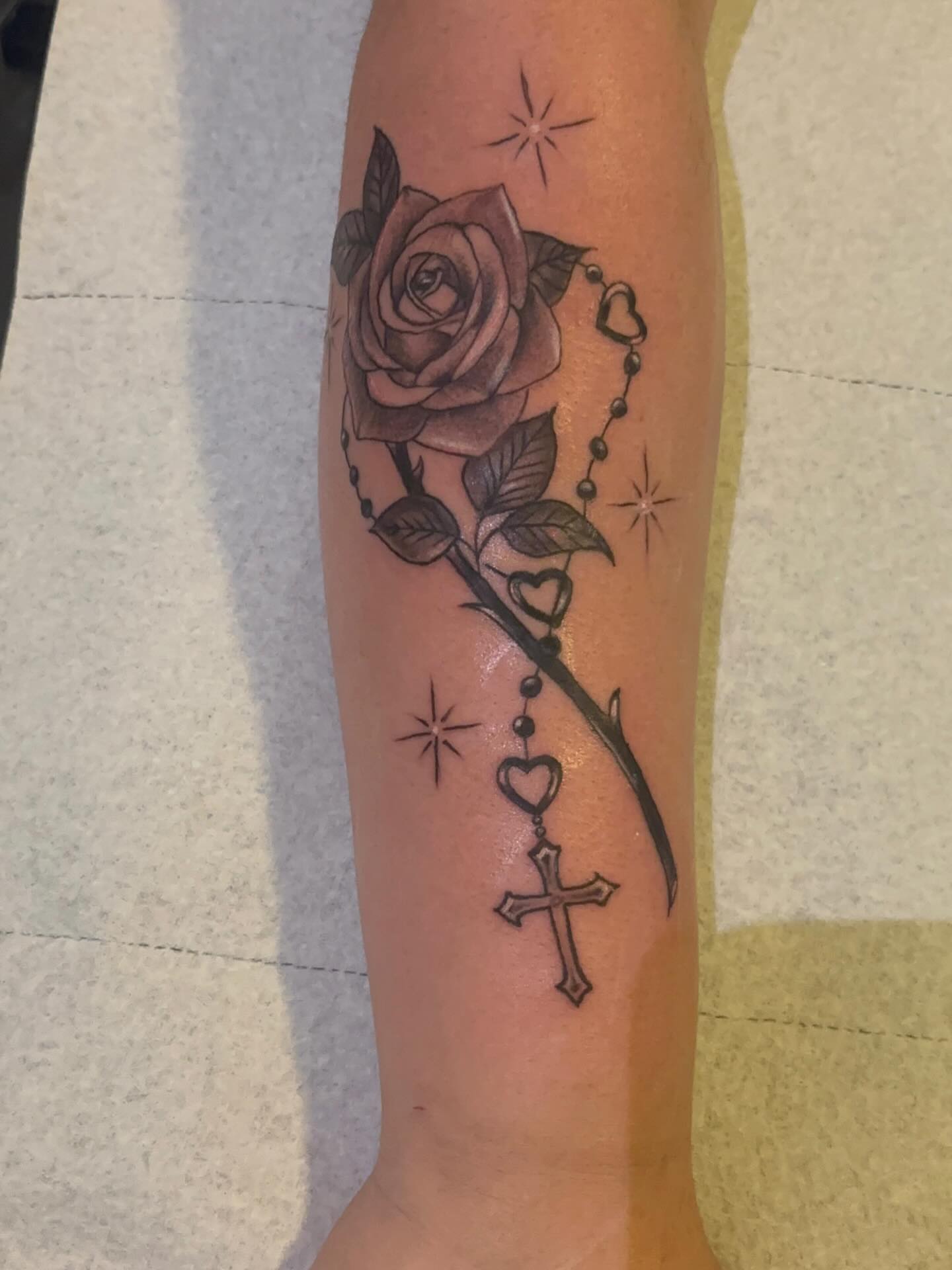 Rose and cross realism tattoo on the forearm by Ana Uriarte π