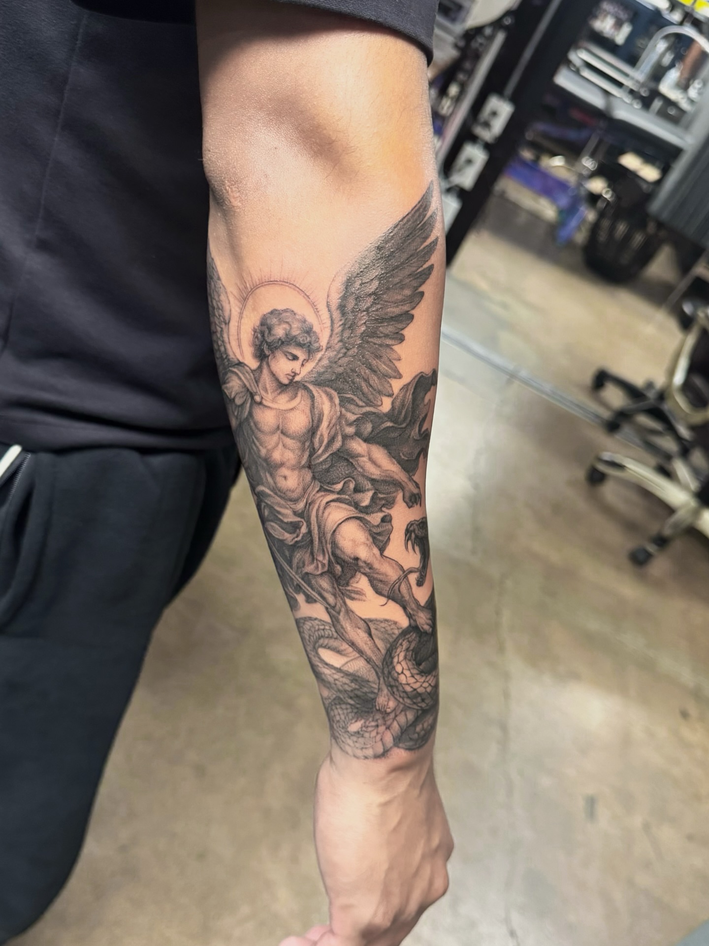Angel slaying dragon realism tattoo on the forearm by Gen Li
