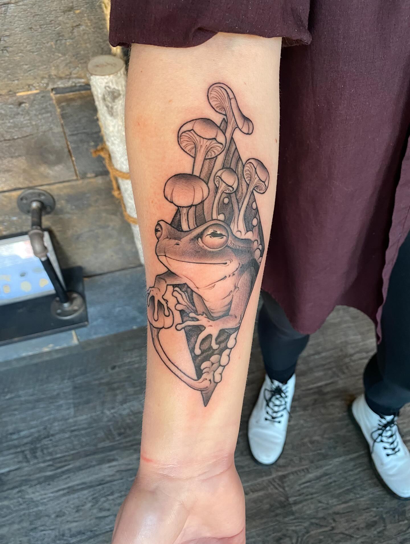 Frog and mushrooms black and grey tattoo on the forearm by Kyle Kozek, Columbus, Ohio