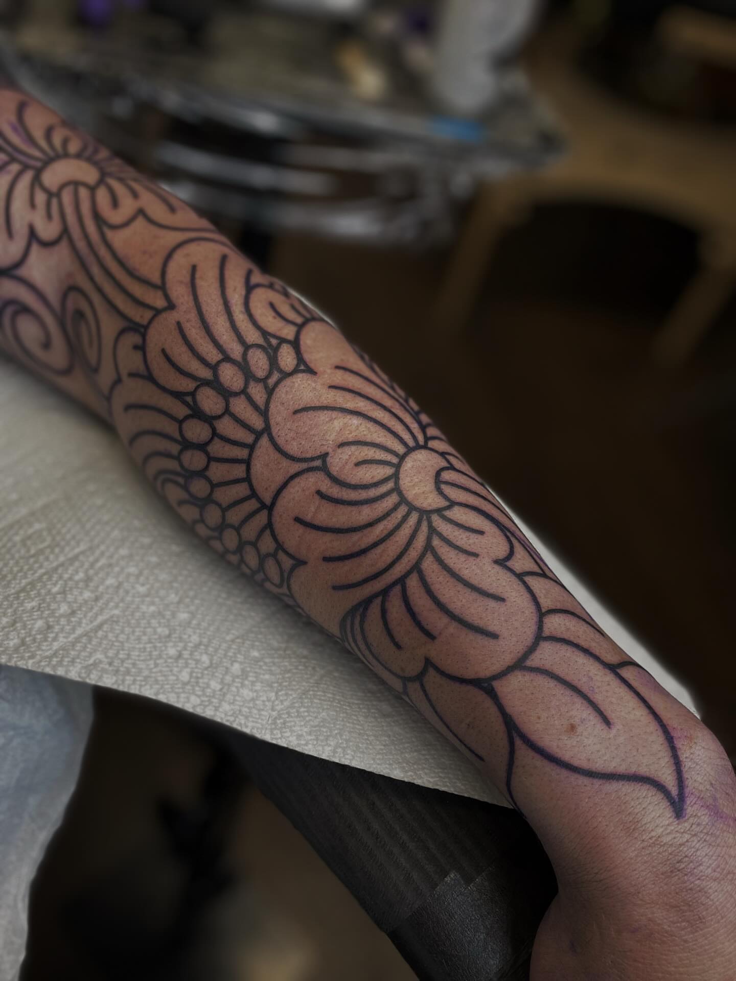 Floral design black and grey tattoo on the forearm by Veronica