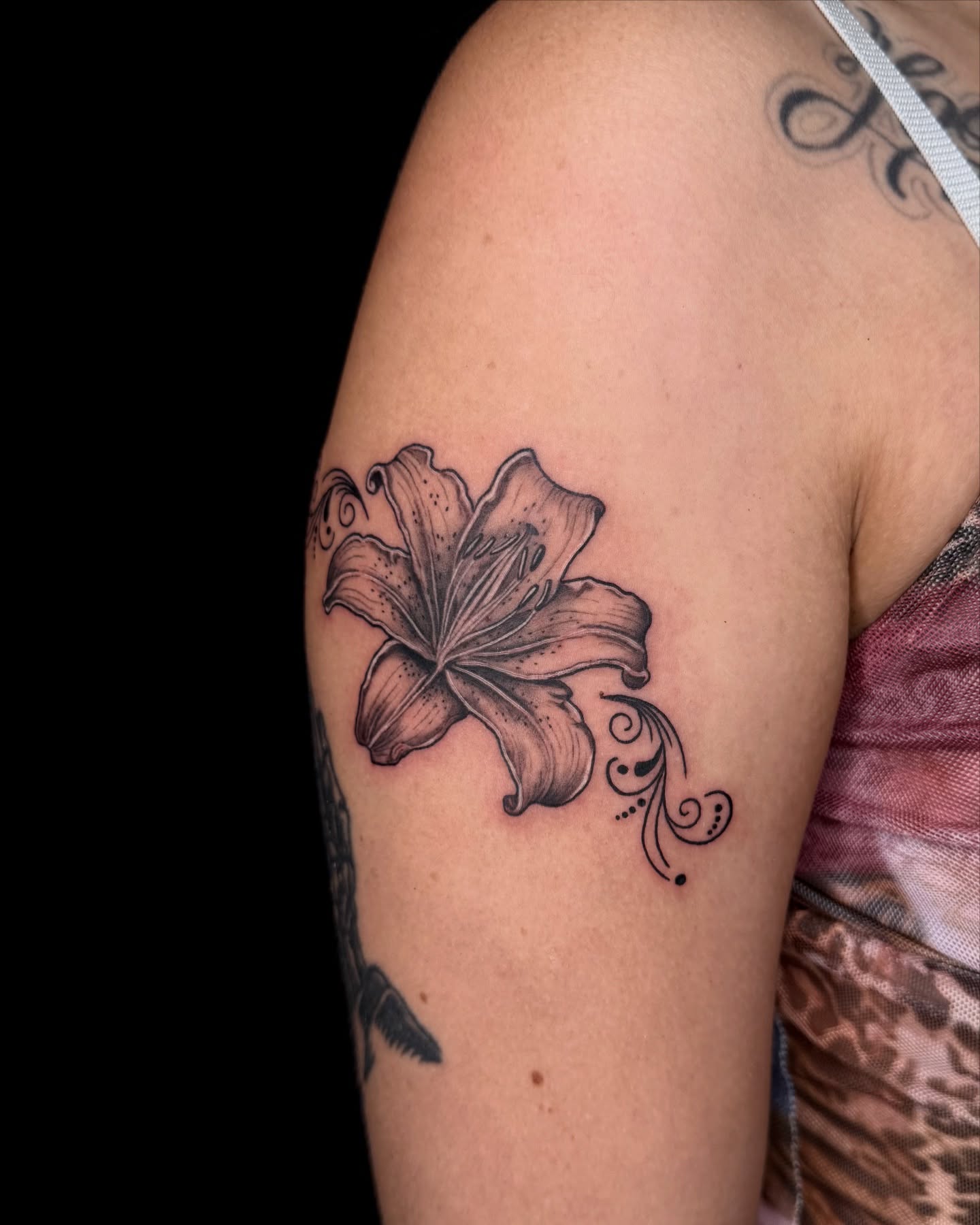 Lily black and grey tattoo on the shoulder by Too Zen